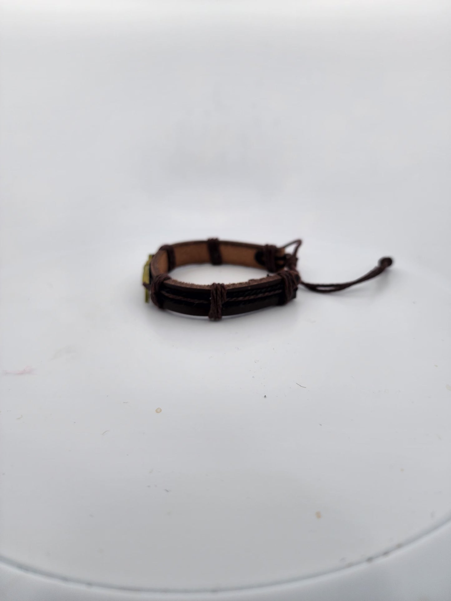 Brown leather bracelet on a white surface