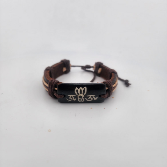 Brown braided bracelet with a black tag featuring a logo on a white background