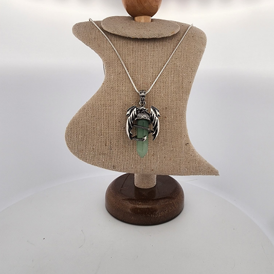 Necklace with a pendant on a mannequin bust against a white background