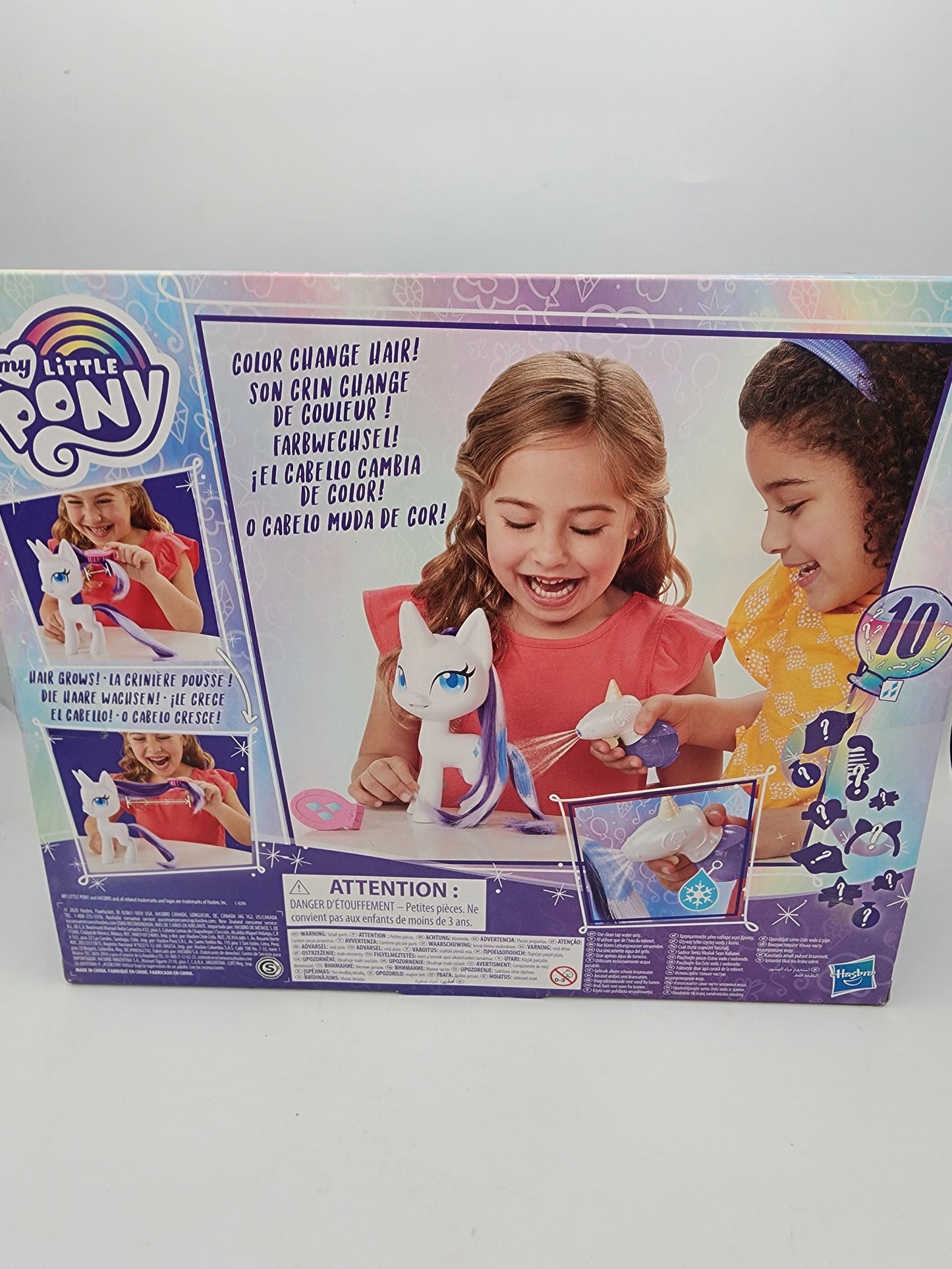 My Little Pony toy set packaging with two children and a pony on a gray background