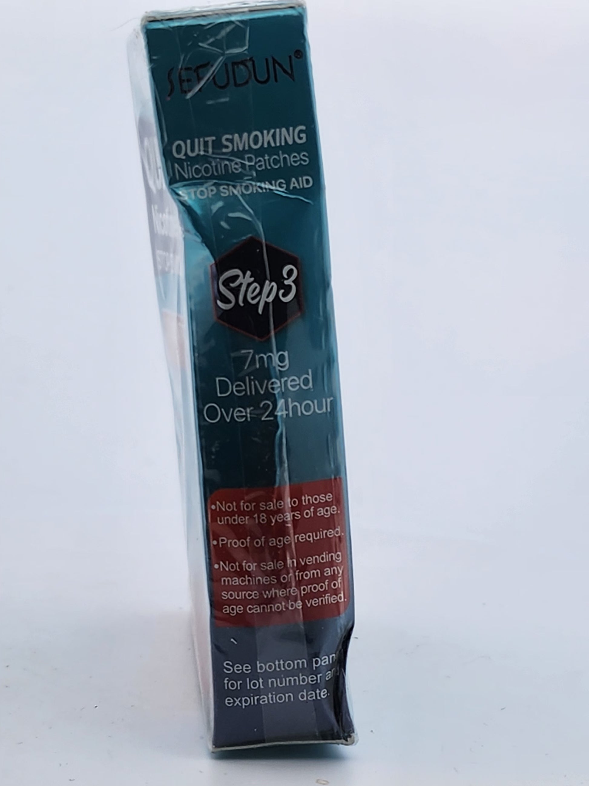 Packaged nicotine patches for quitting smoking on a white background