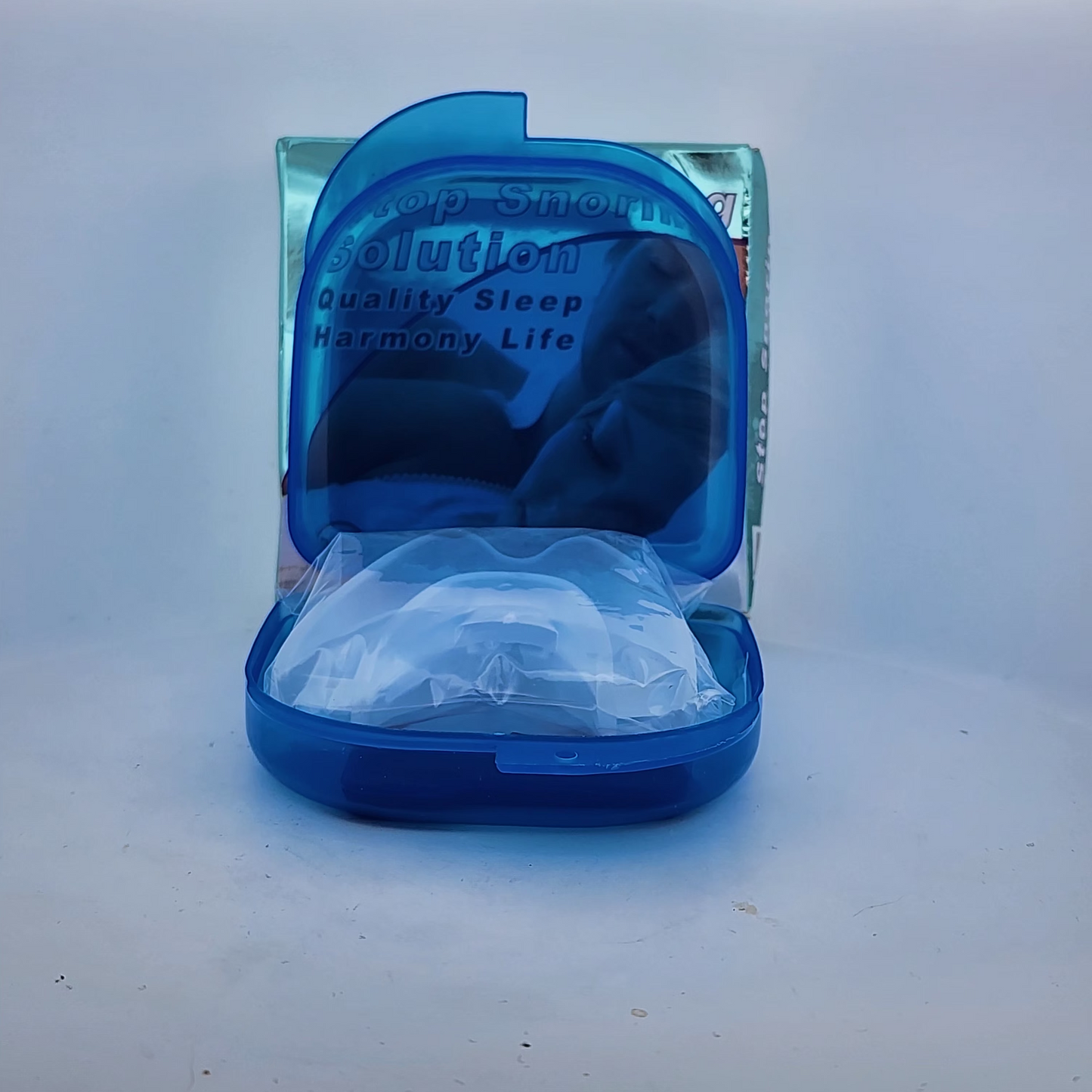 Blue mouthguard case with a clear mouthguard inside on a white background