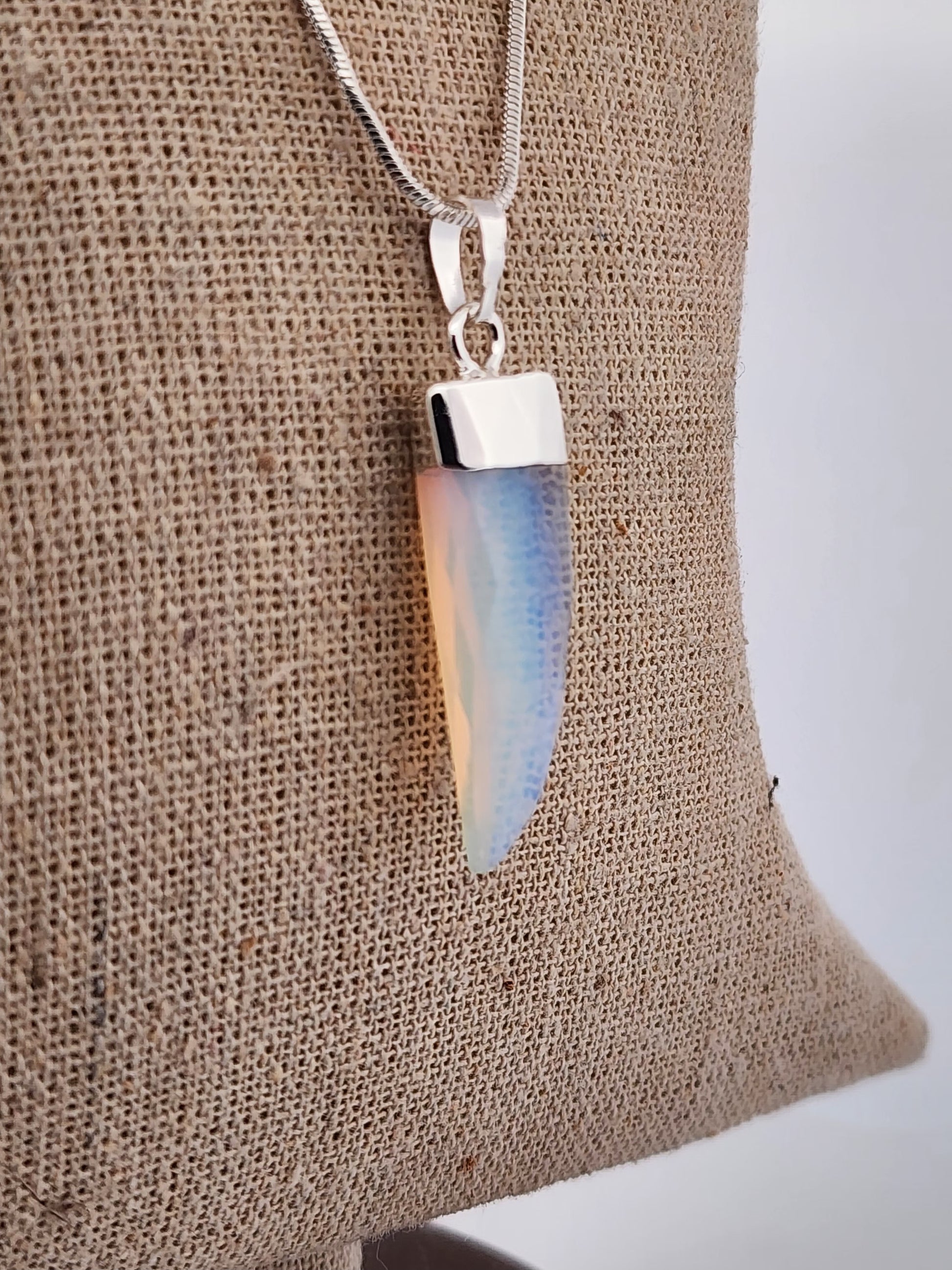 Necklace with a pendant on a textured fabric background