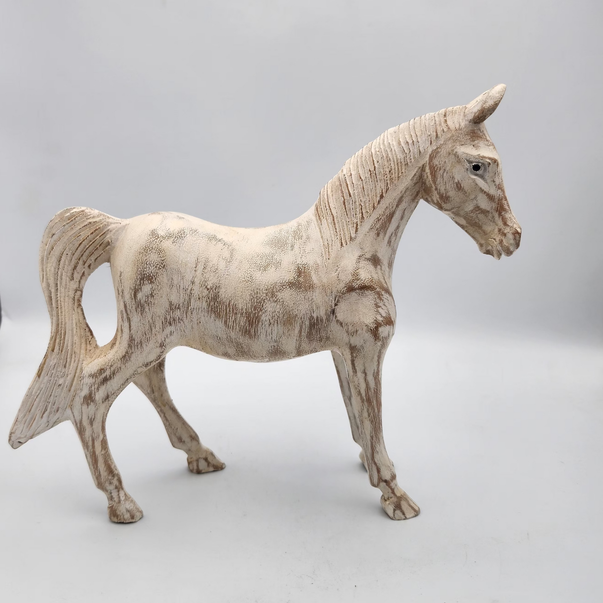 White horse figurine on a white background