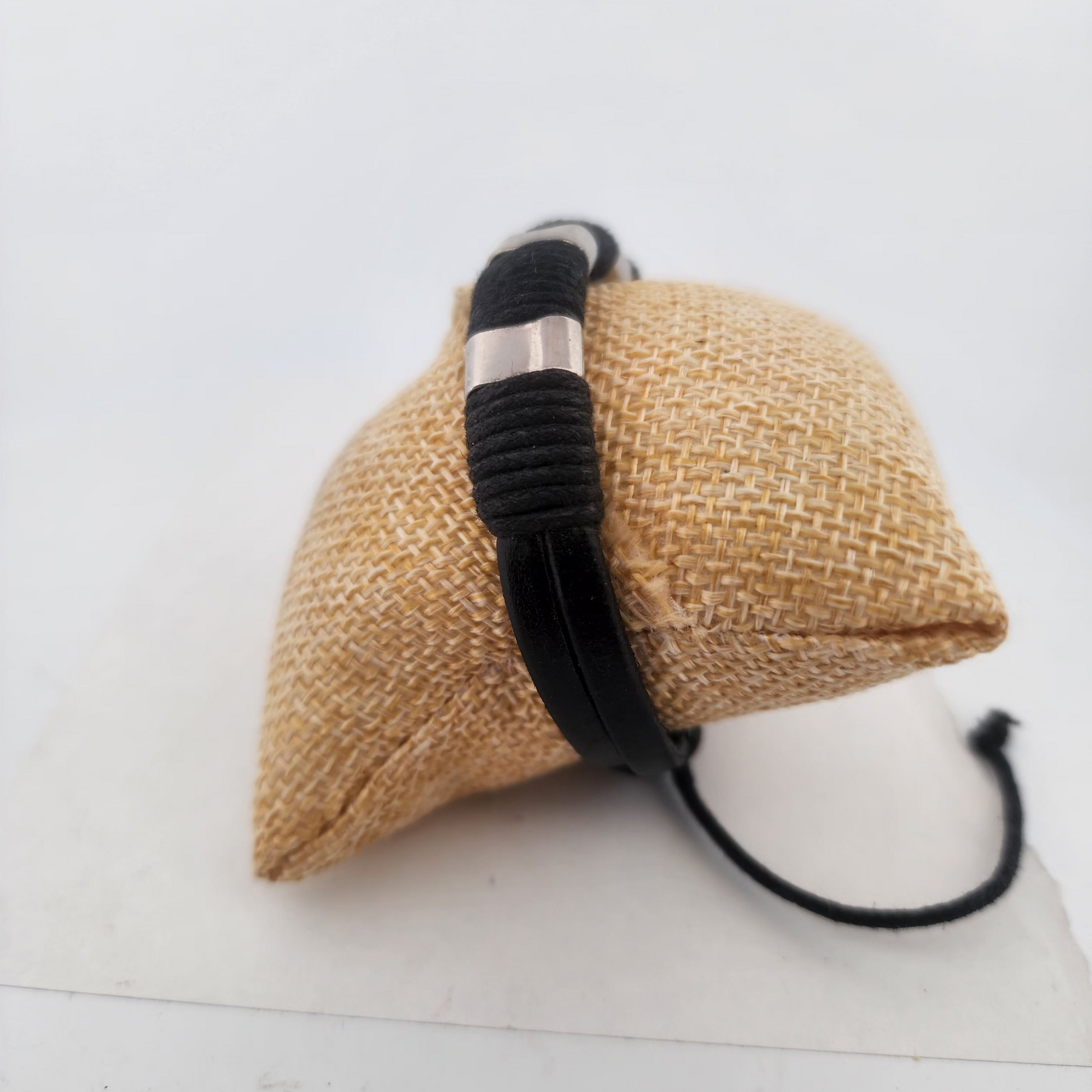 Woven bag with a black strap on a white background