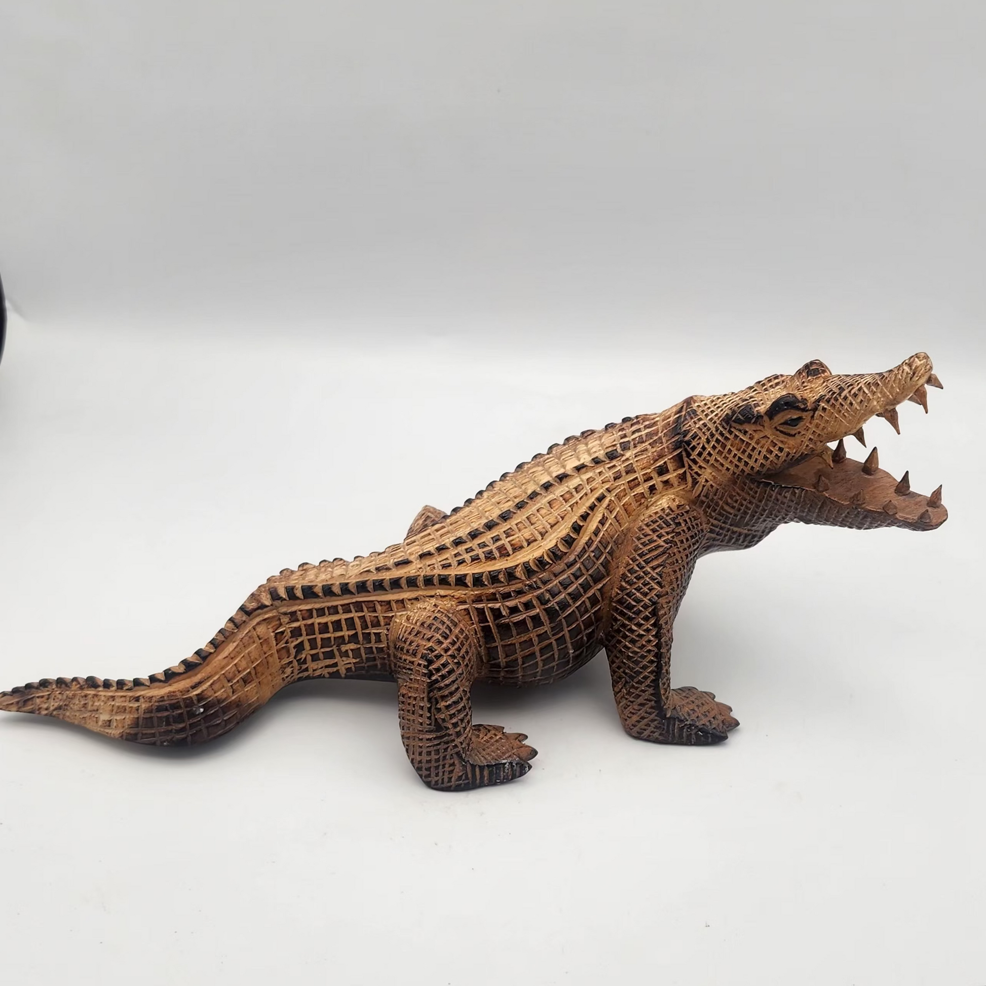 hand carved soro wood alligator on a white background 