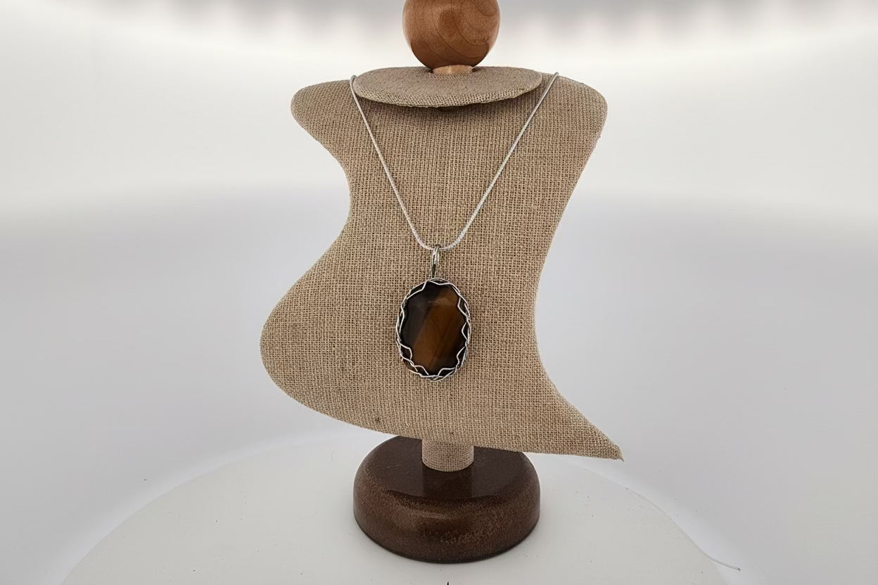 Necklace with a pendant on a mannequin bust against a white background