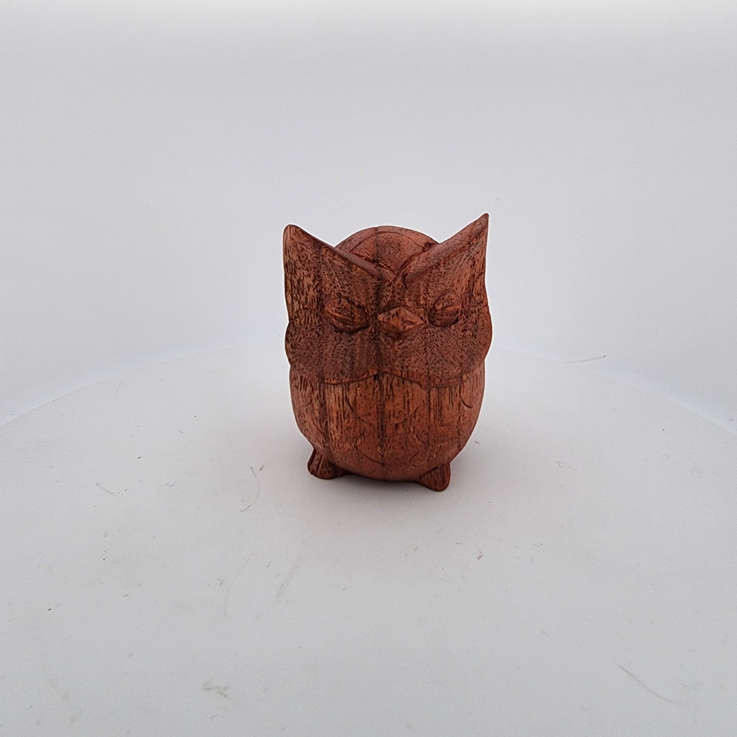 Wooden owl figurine on a white background