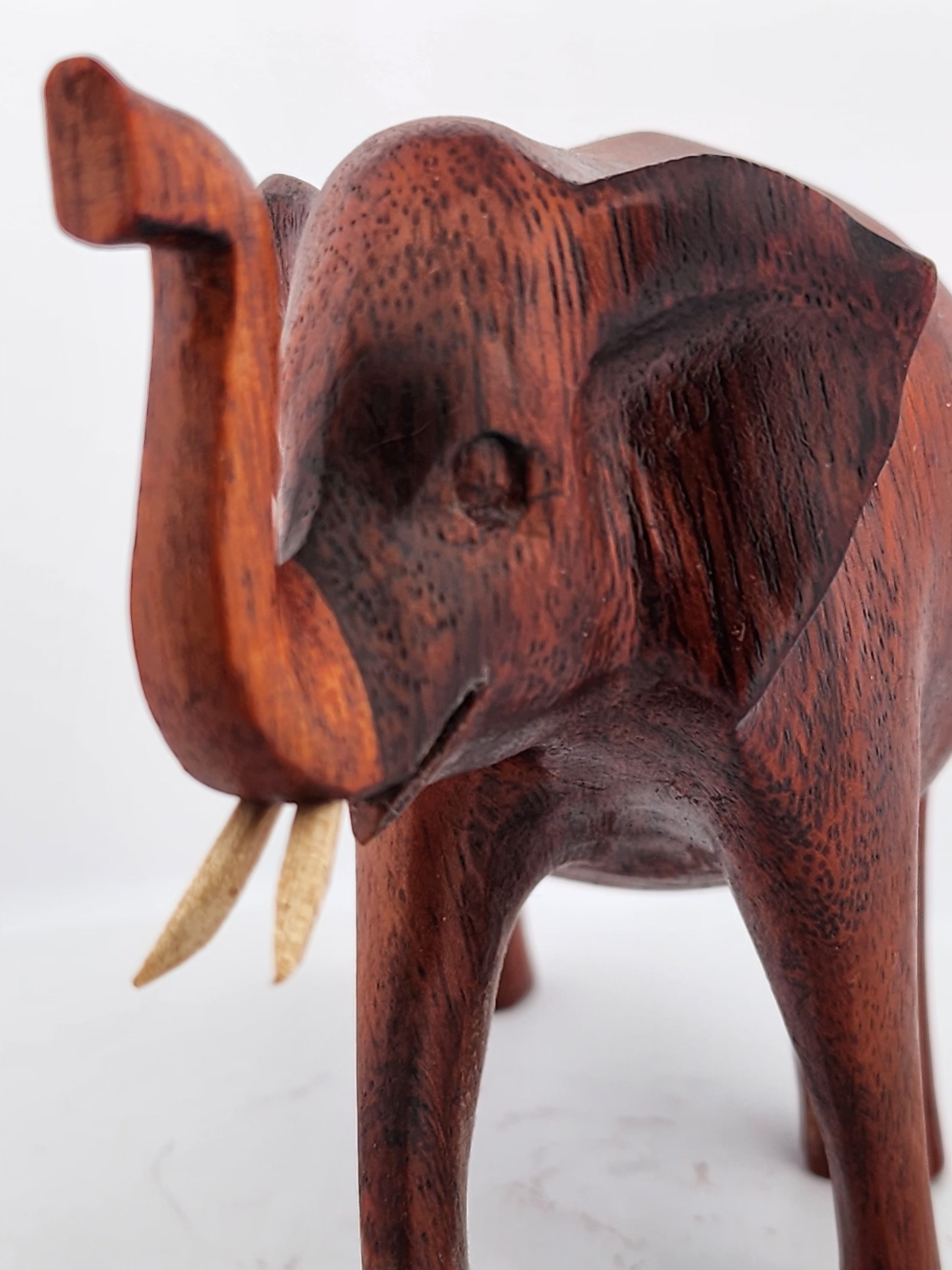 Wooden elephant sculpture on a white background