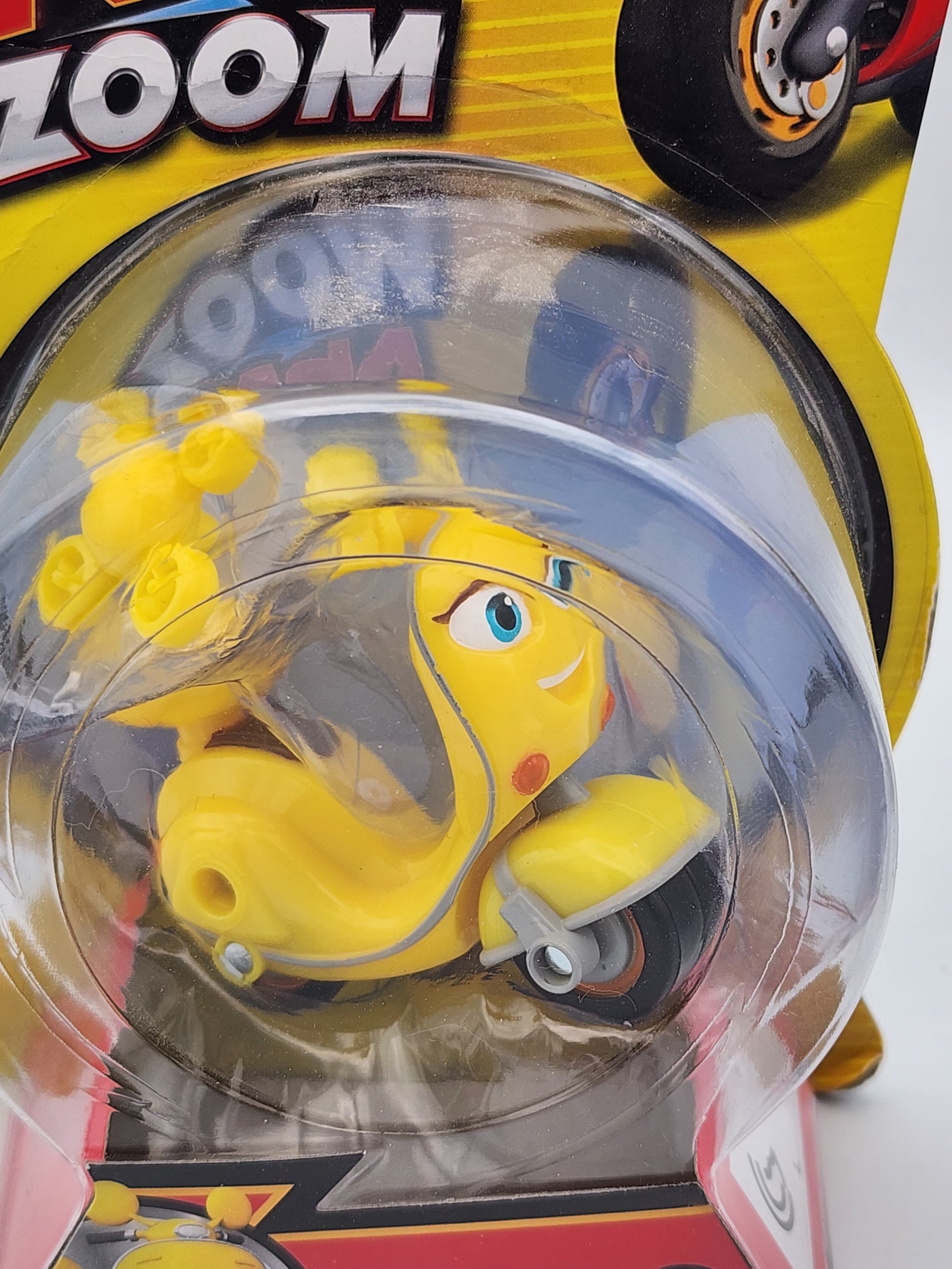 Yellow toy figure in a clear bubble on a yellow background with 'Zoom' branding.