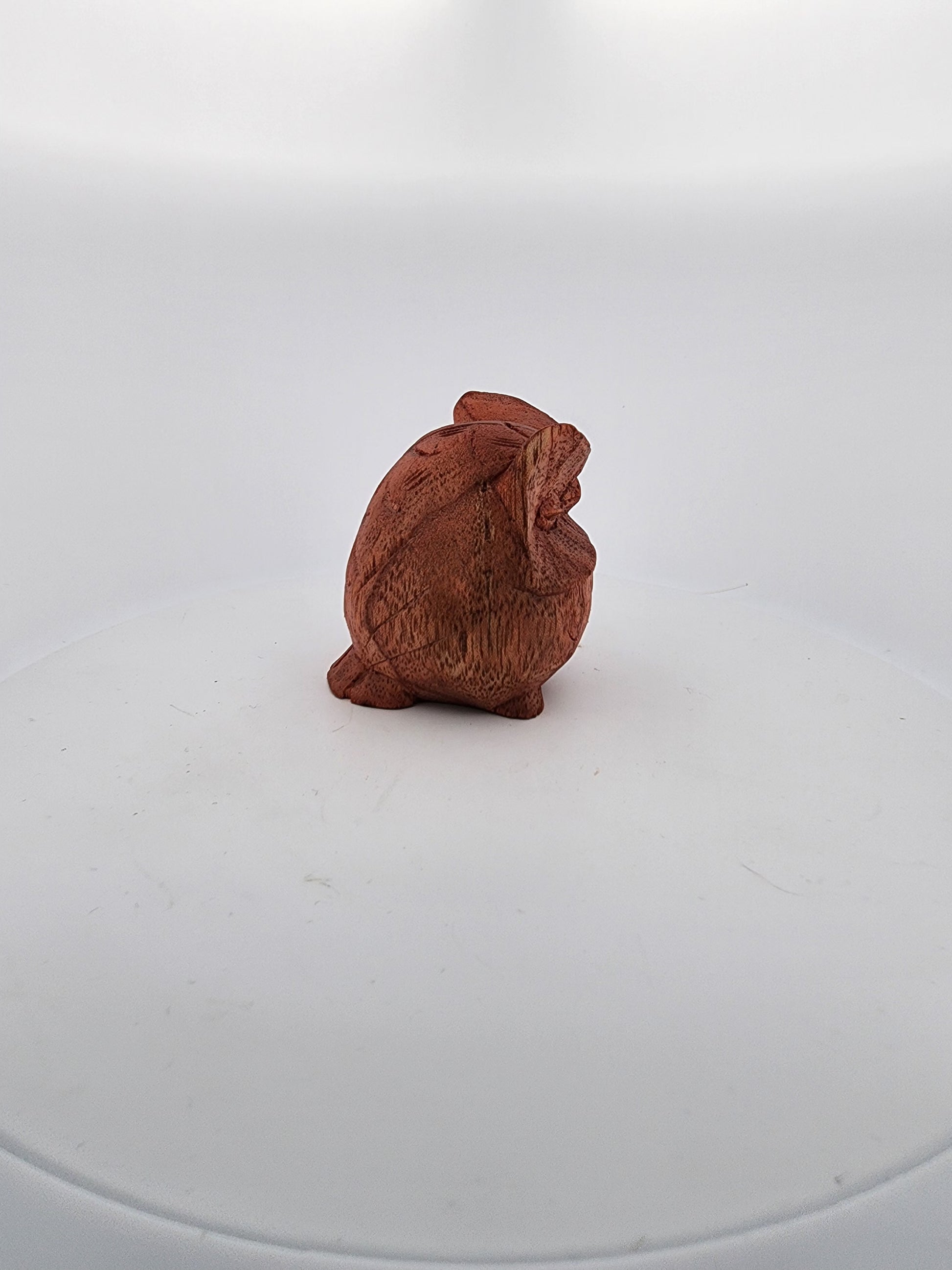 Small brown ceramic rabbit figurine on a white background