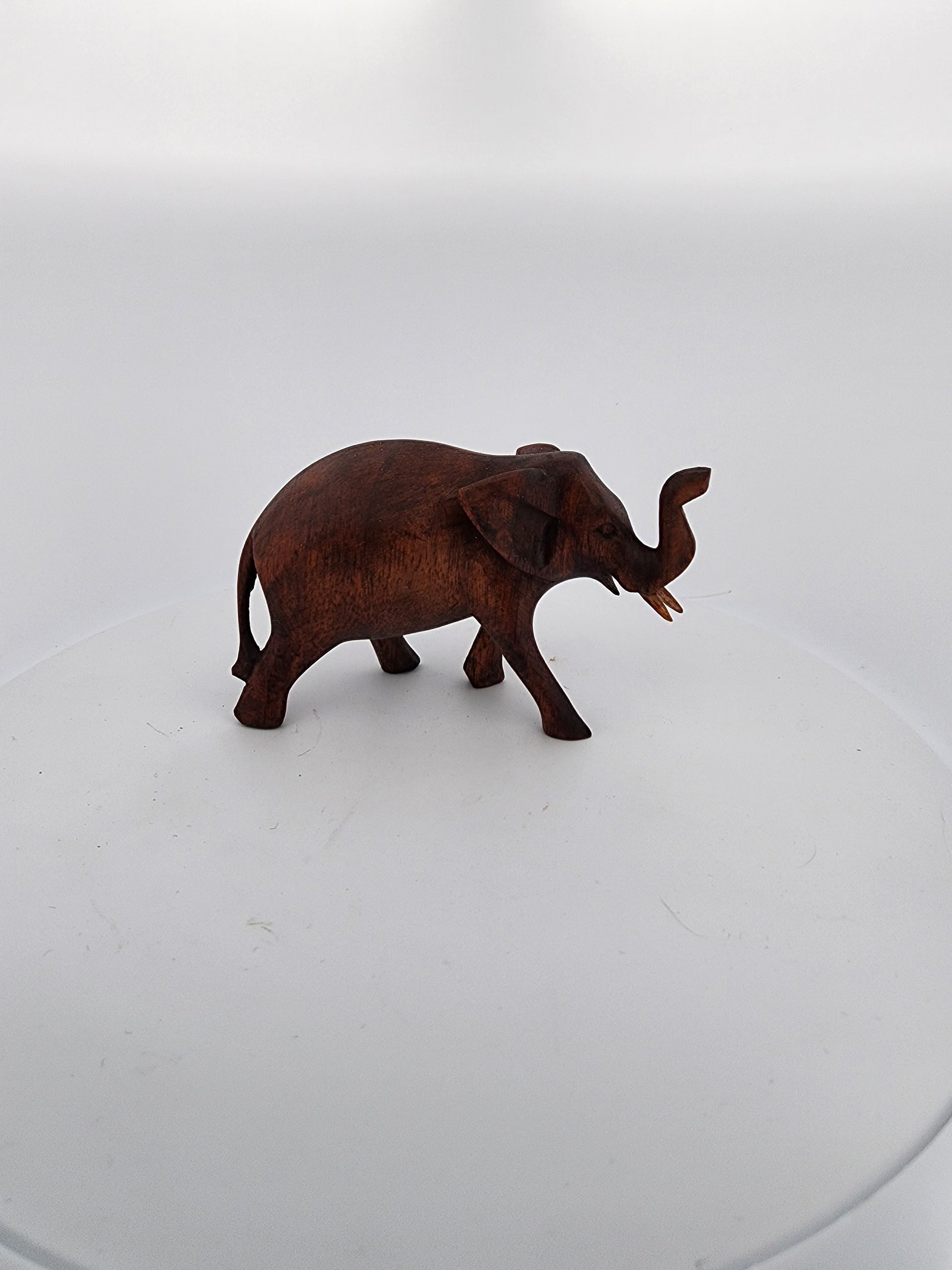 Bronze elephant figurine on a white background