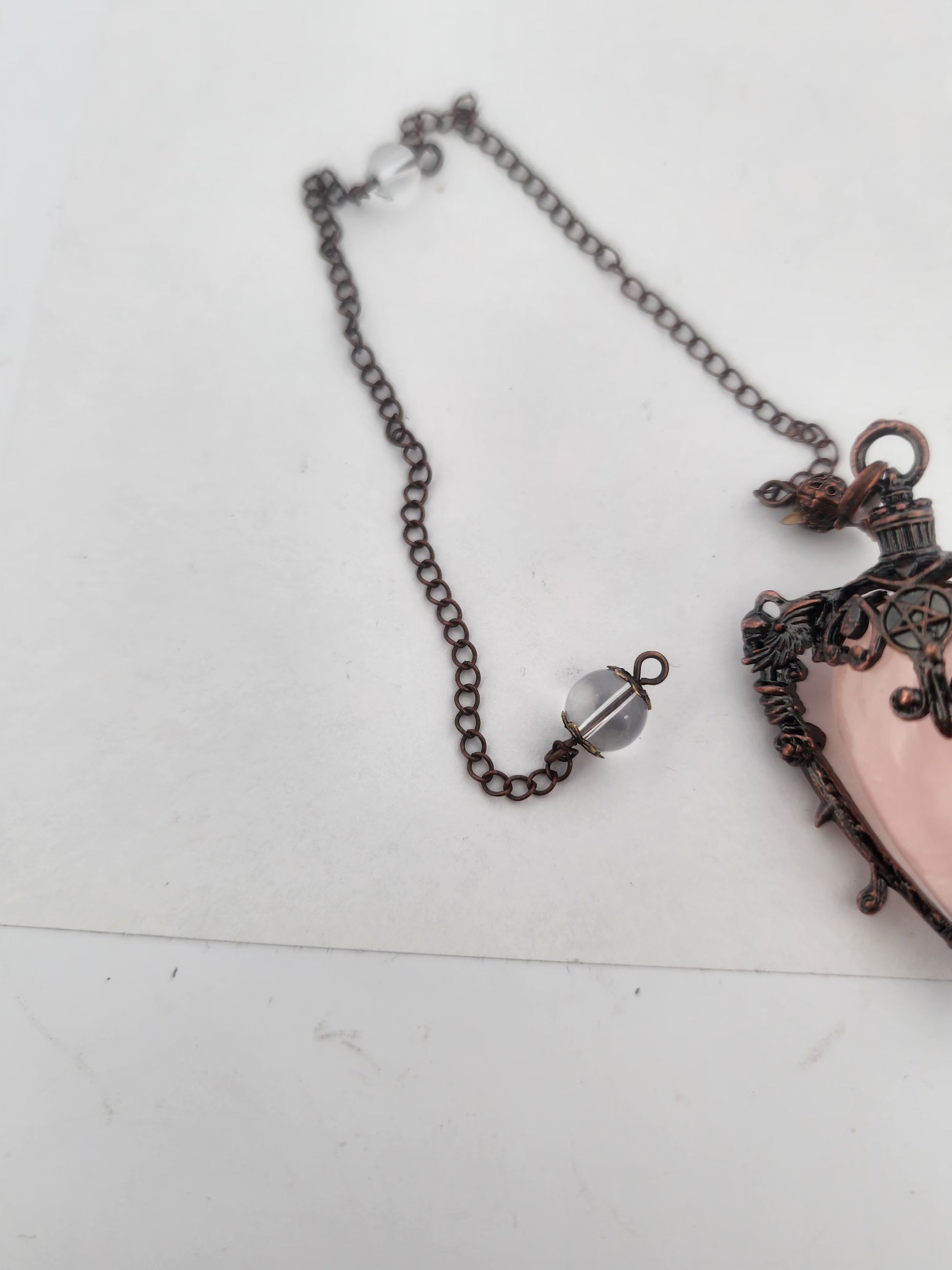 Necklace with a decorative pendant on a white surface