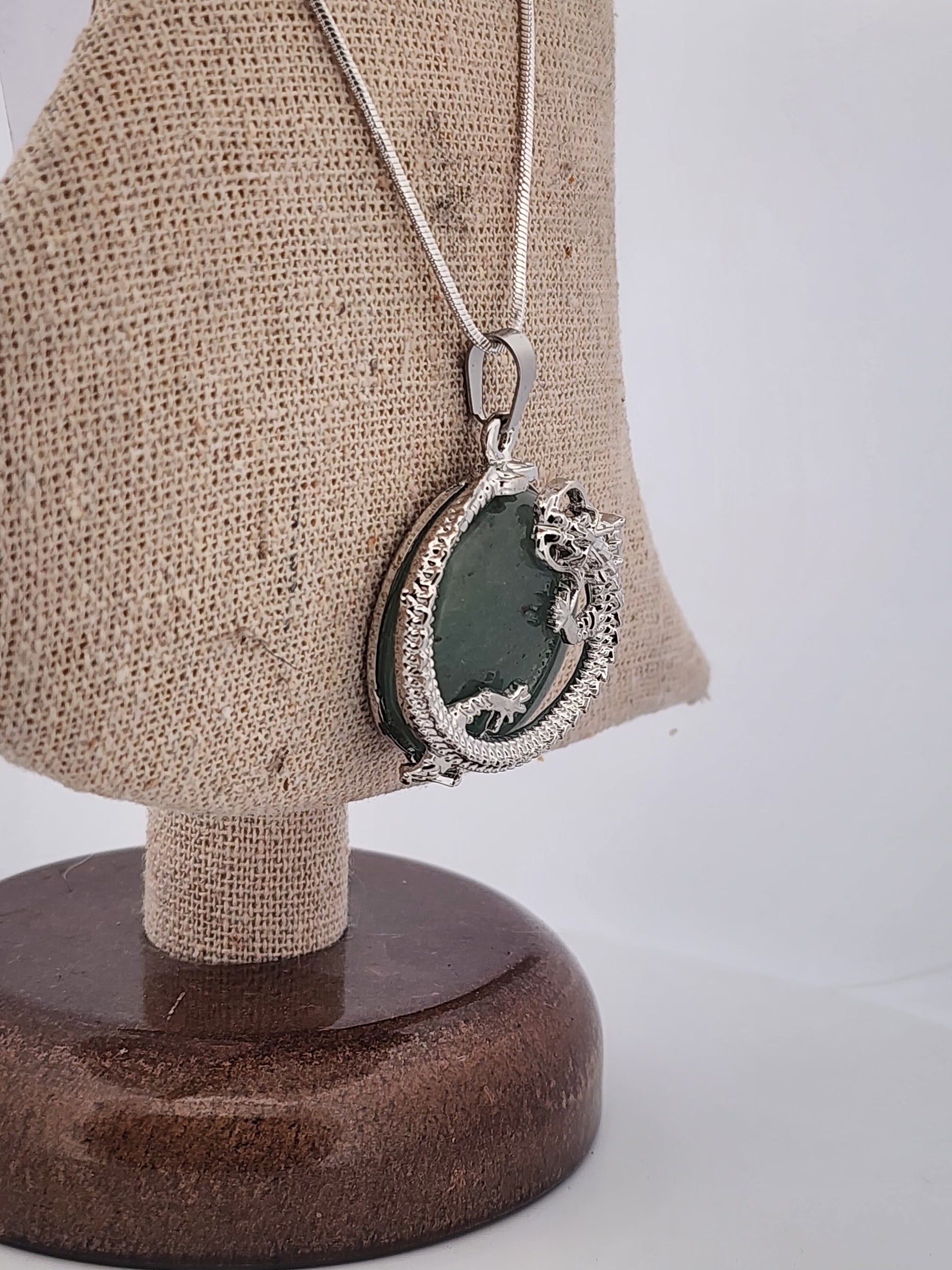 Necklace with a pendant on a mannequin bust against a white background