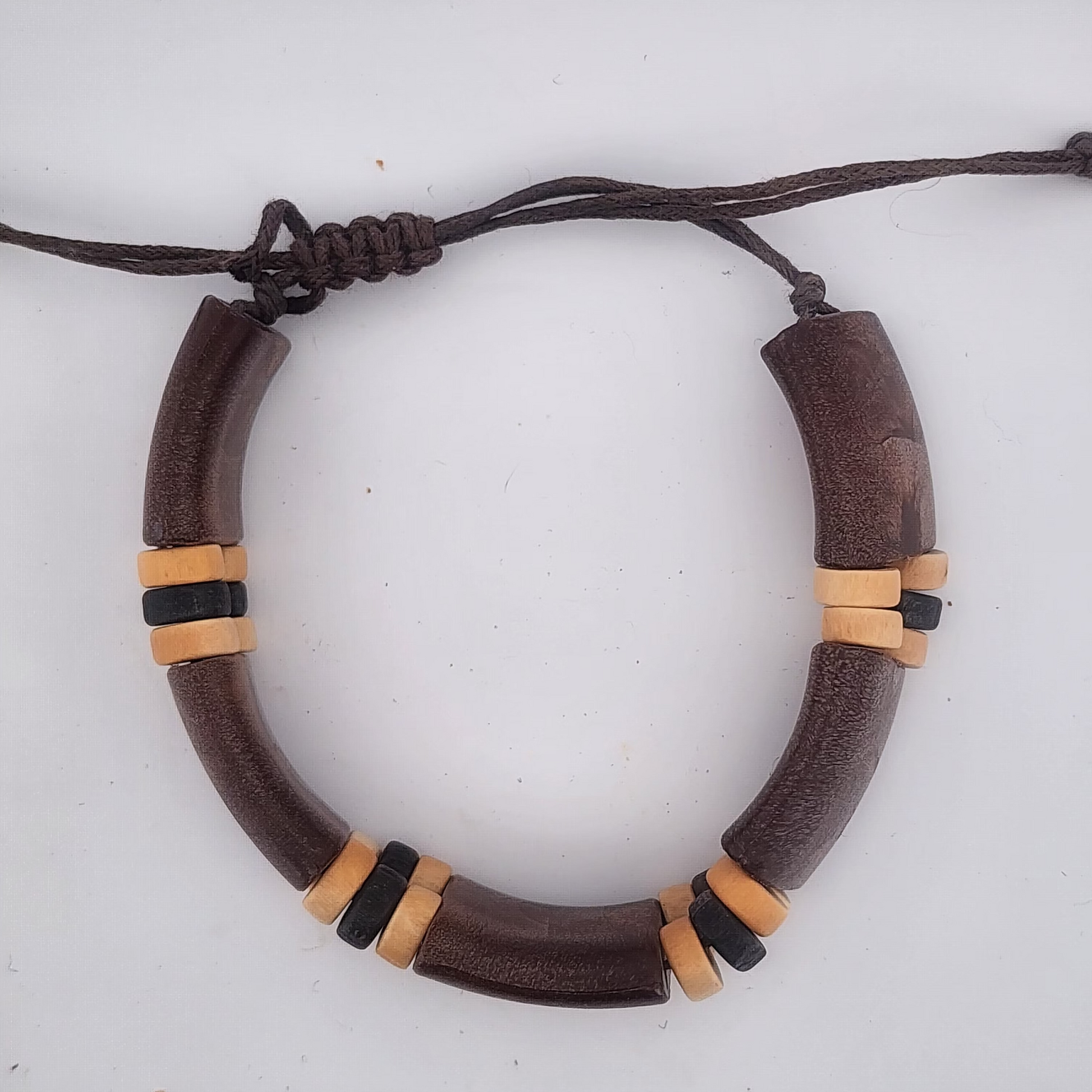 Bracelet with brown and beige beads on a white background