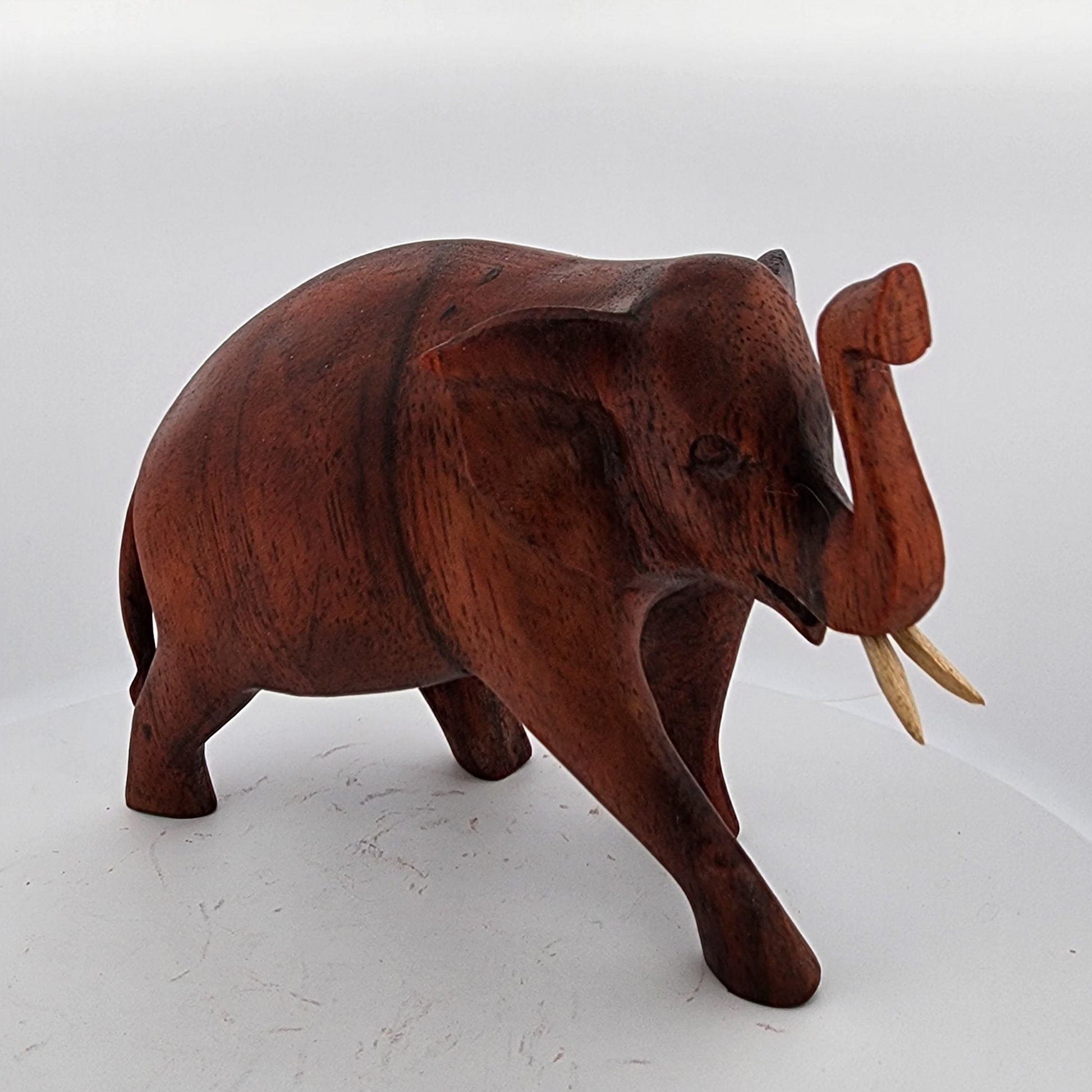 Wooden elephant figurine on a white background