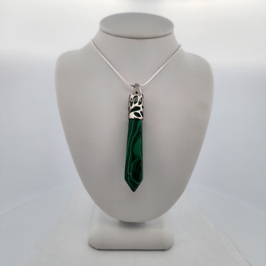 Necklace with a green pendant on a mannequin bust against a white background