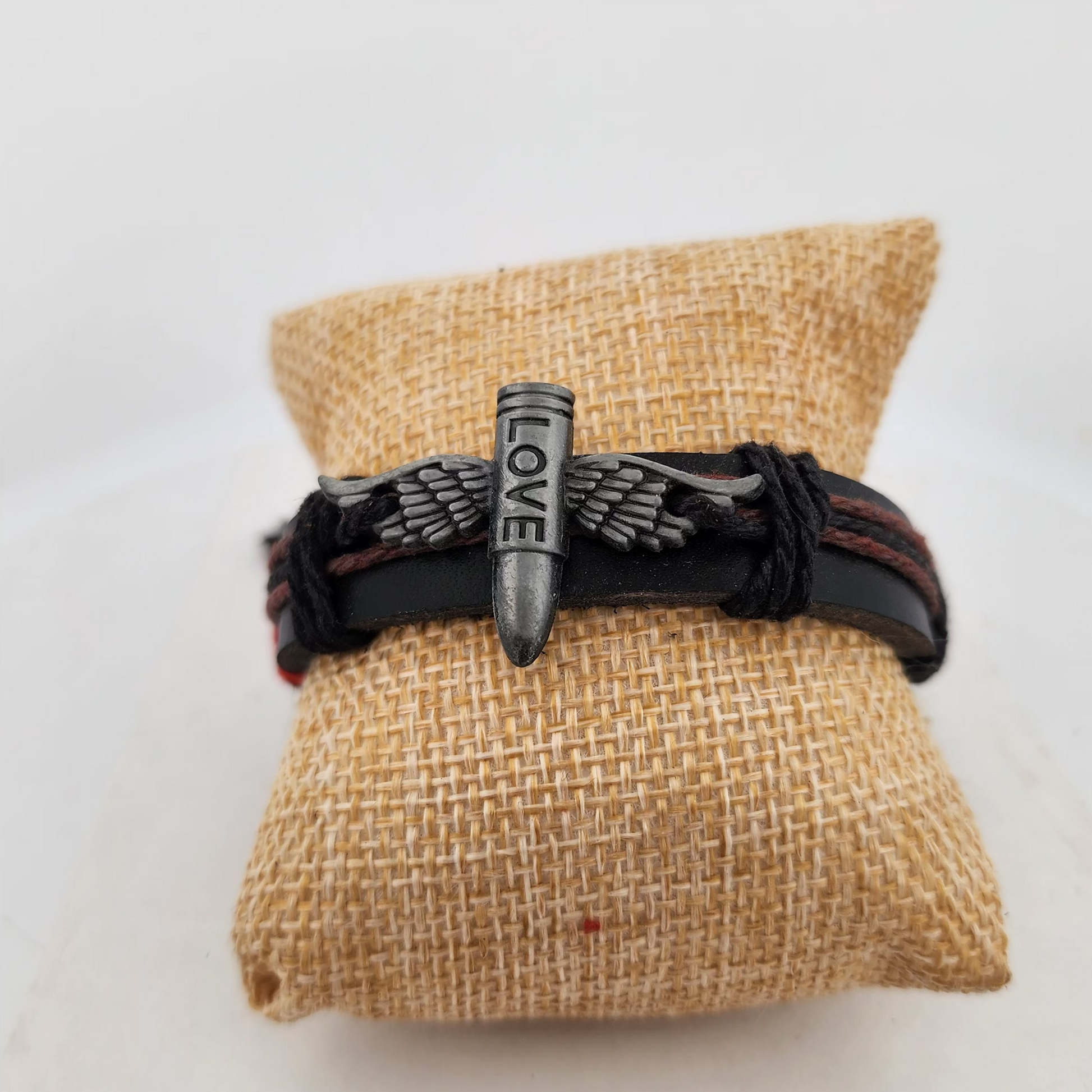 Bracelet with 'LOVE' charm on a burlap surface