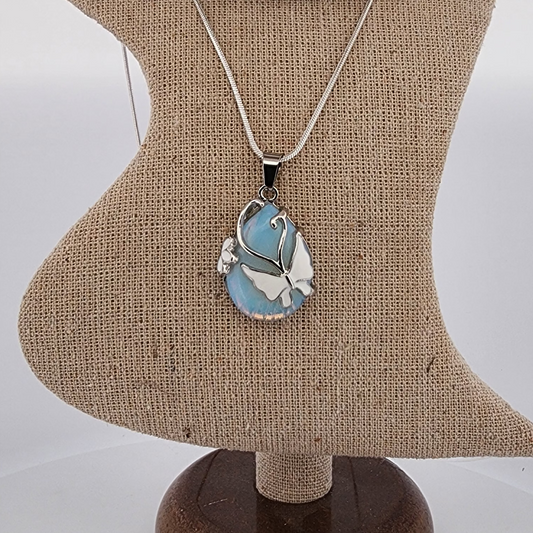 Necklace with a pendant on a mannequin bust against a plain background