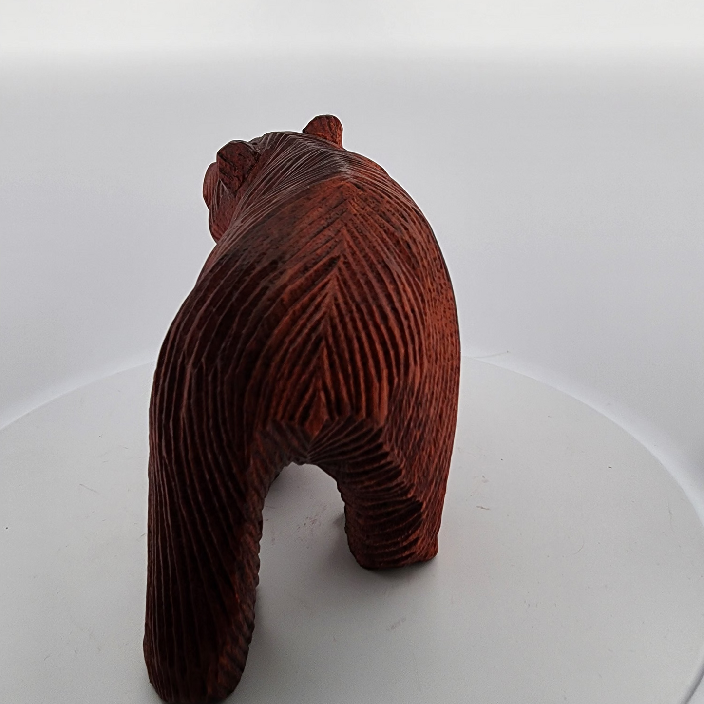 Wooden bear figurine on a white surface