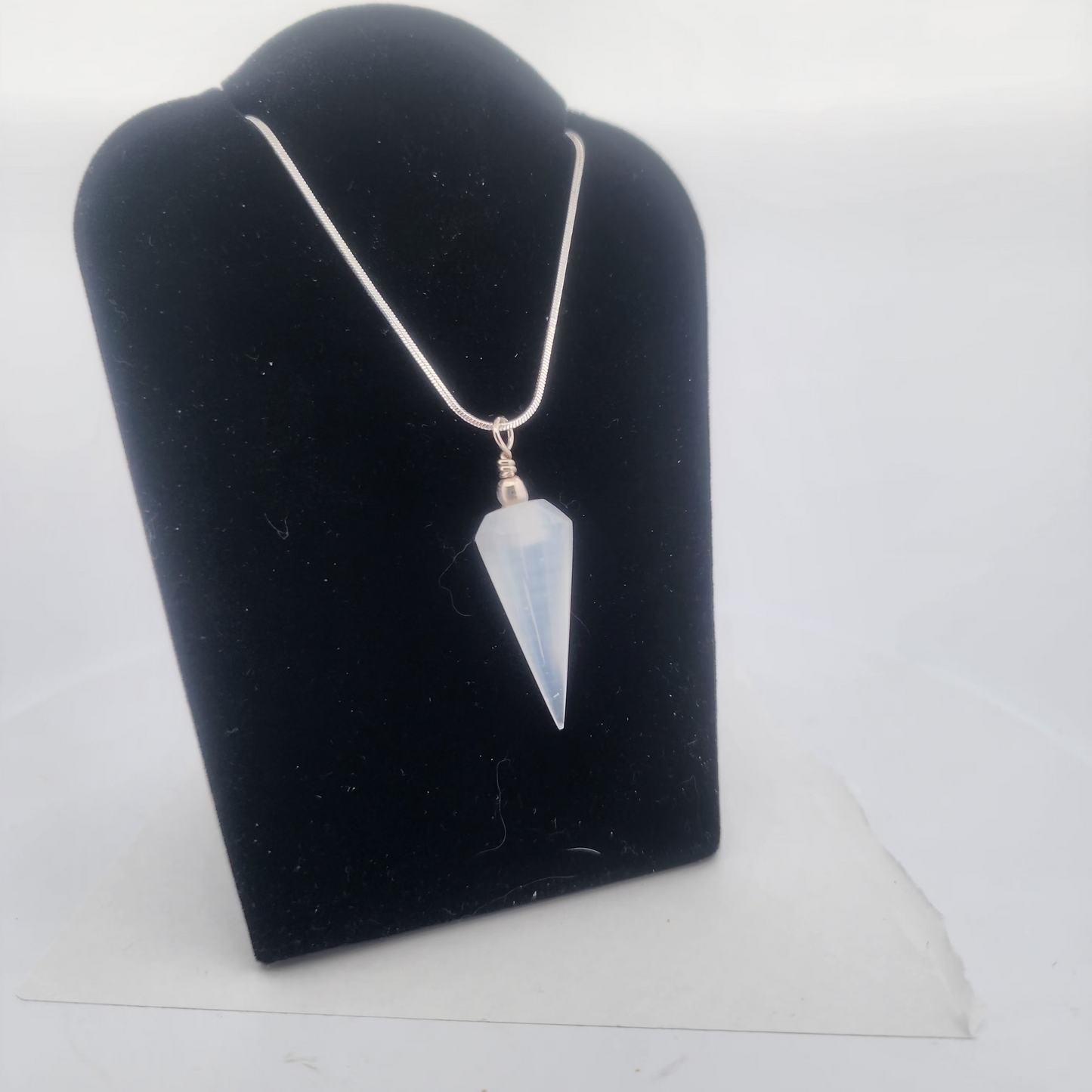 Necklace with a pendant on a black jewelry display