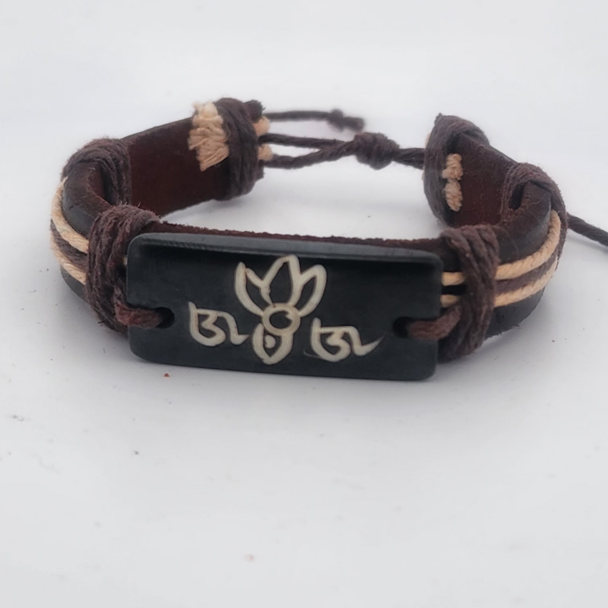 Bracelet with braided design and black tag featuring a logo on a white background