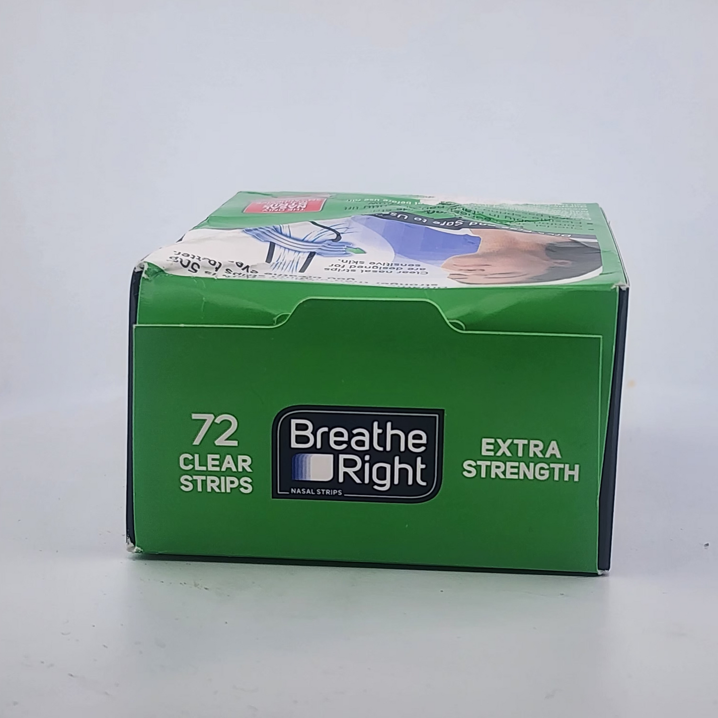 Box of Breathe Right clear strips on a gray background