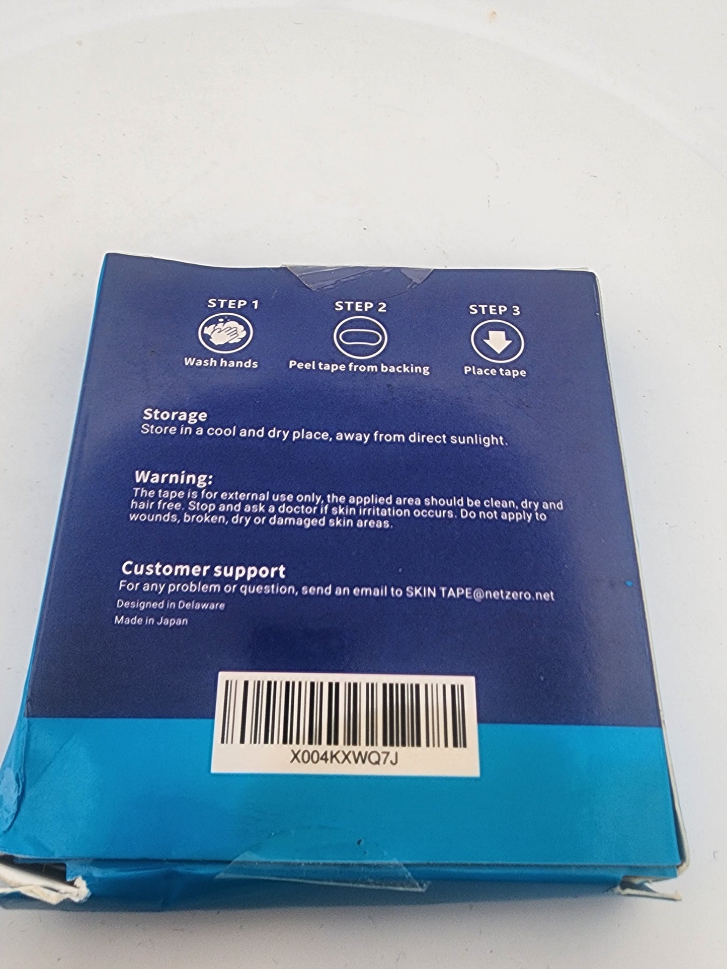 Blue package with instructions and a barcode on a white background