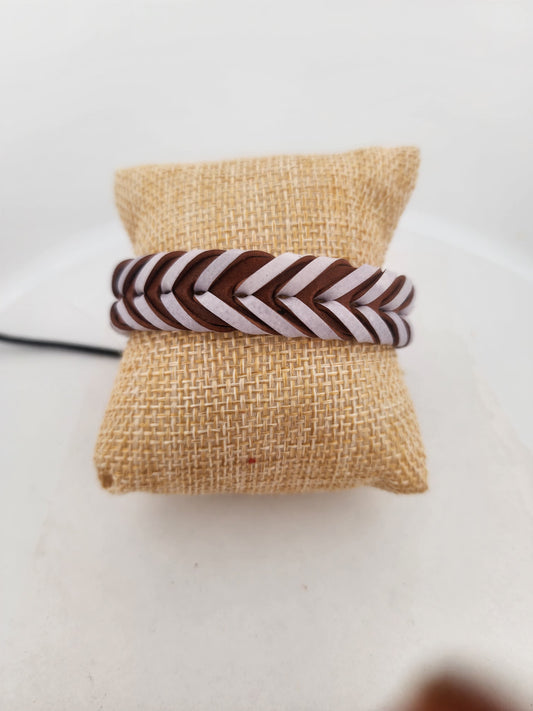 Brown and white striped hair tie on a burlap surface