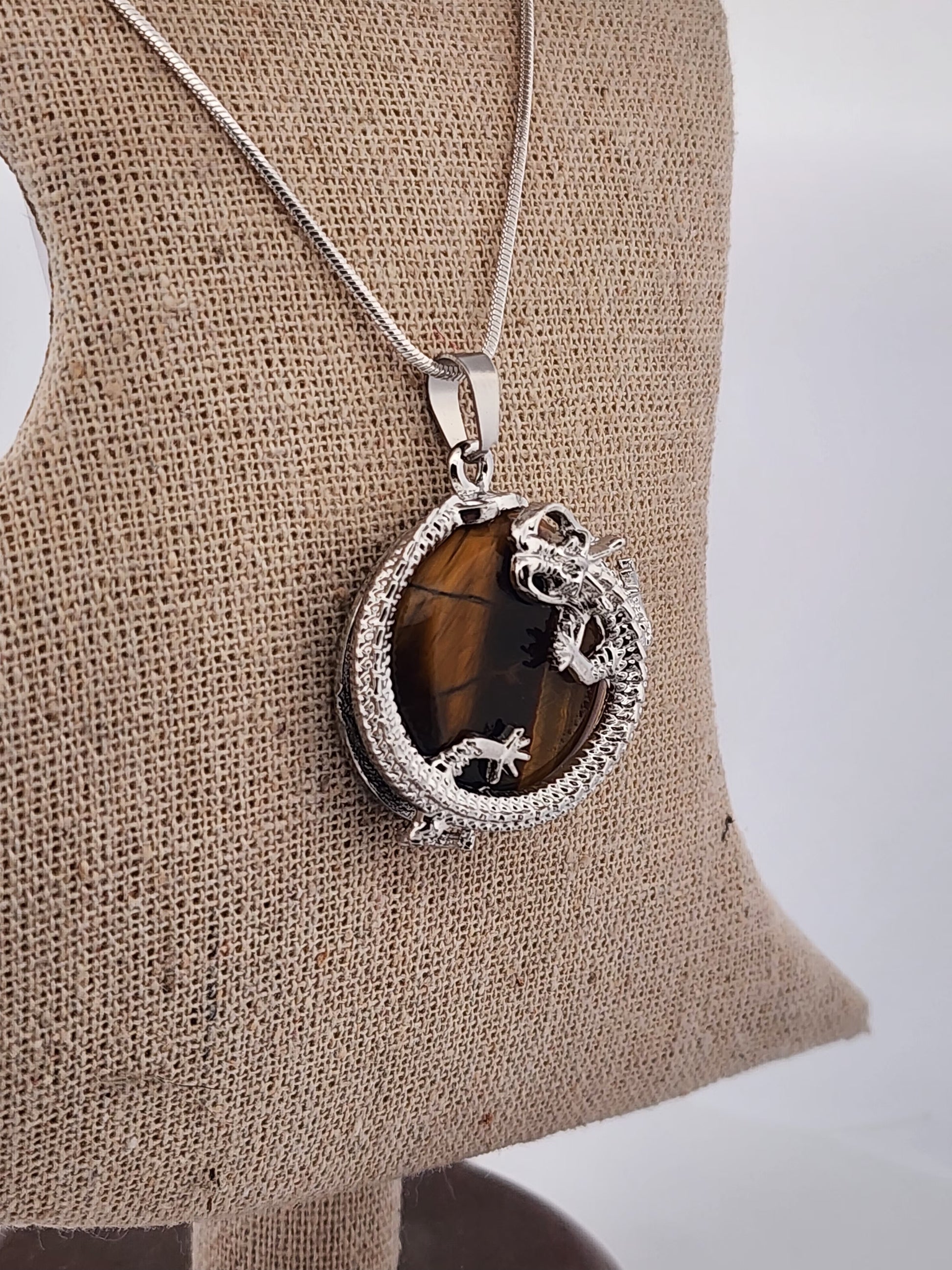 Necklace with a pendant on a mannequin bust against a white background