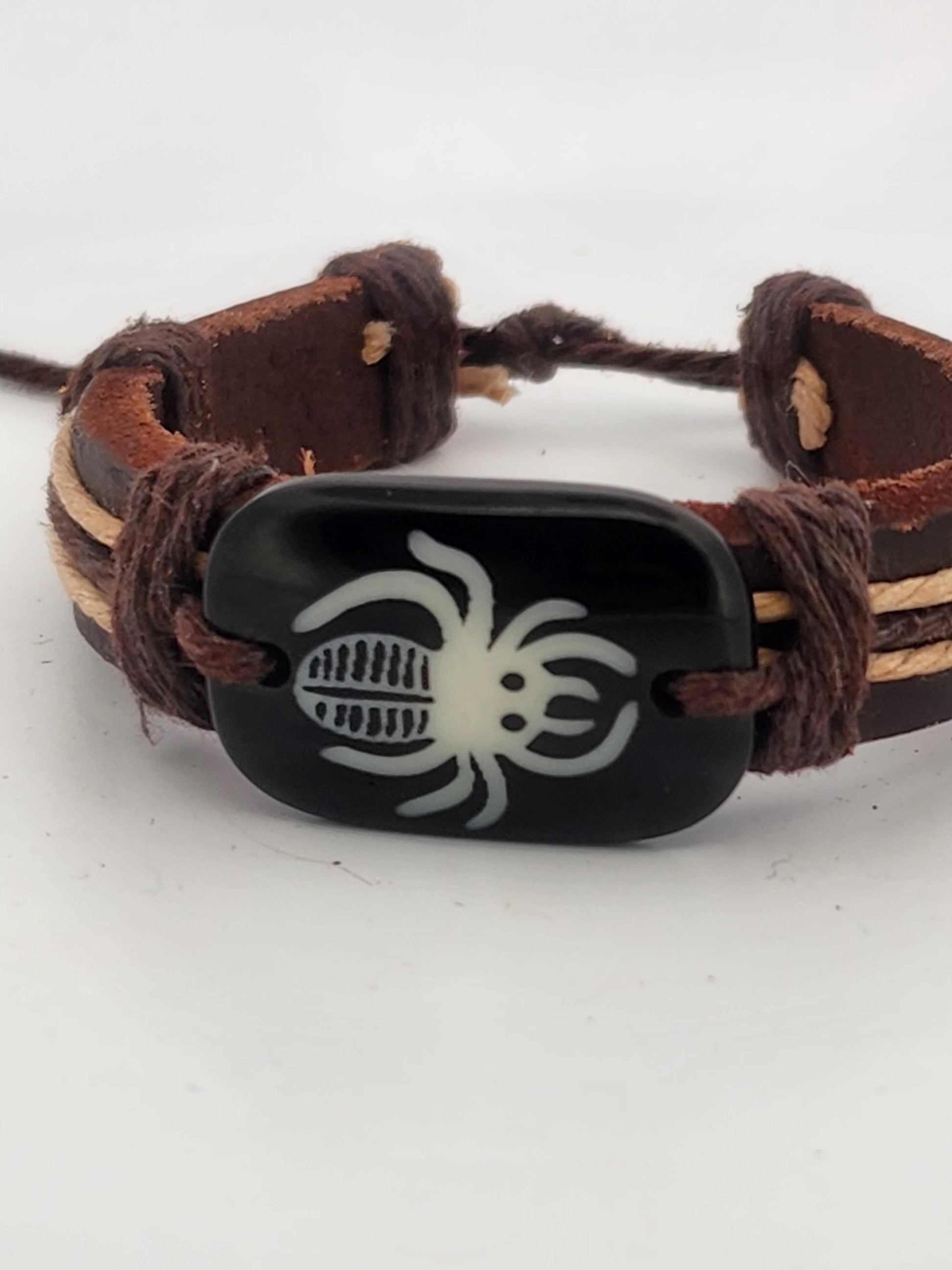 Bracelet with a black spider symbol on a white background
