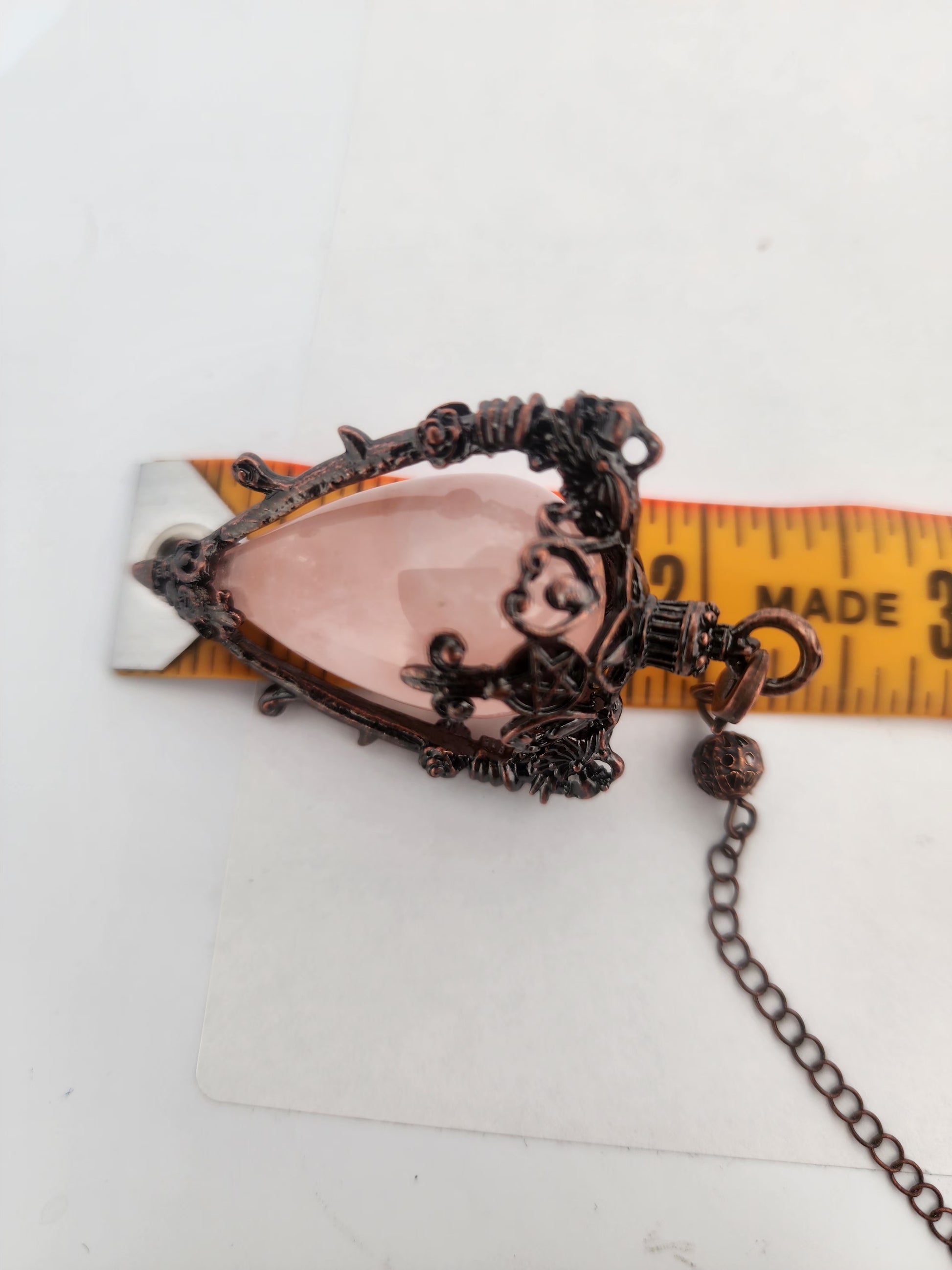 Decorative brooch with chain on a white background
