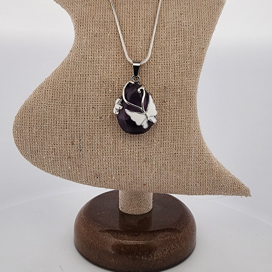 Necklace with a pendant on a mannequin bust against a white background