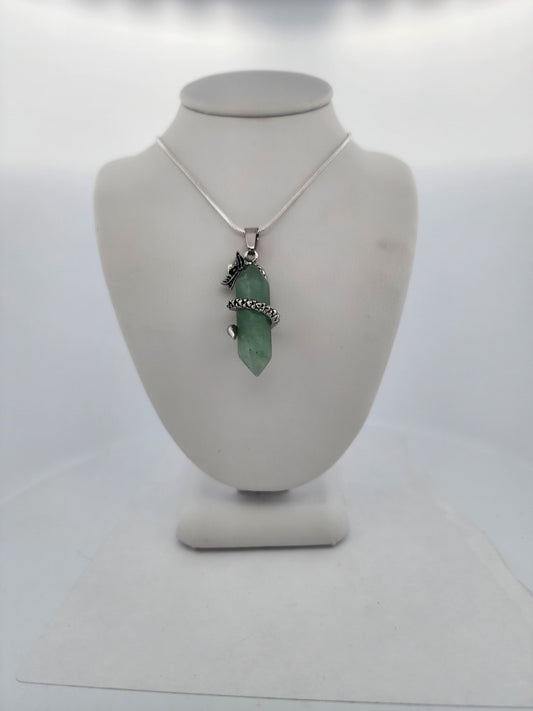 Necklace with a green pendant on a mannequin bust against a white background