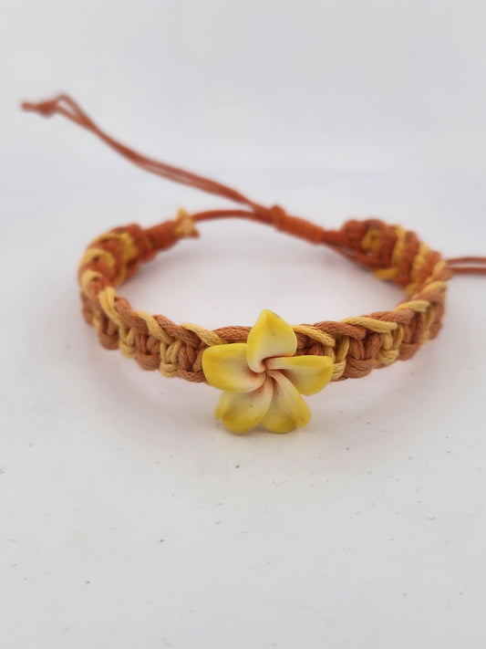 Bracelet with a yellow flower charm on a white background
