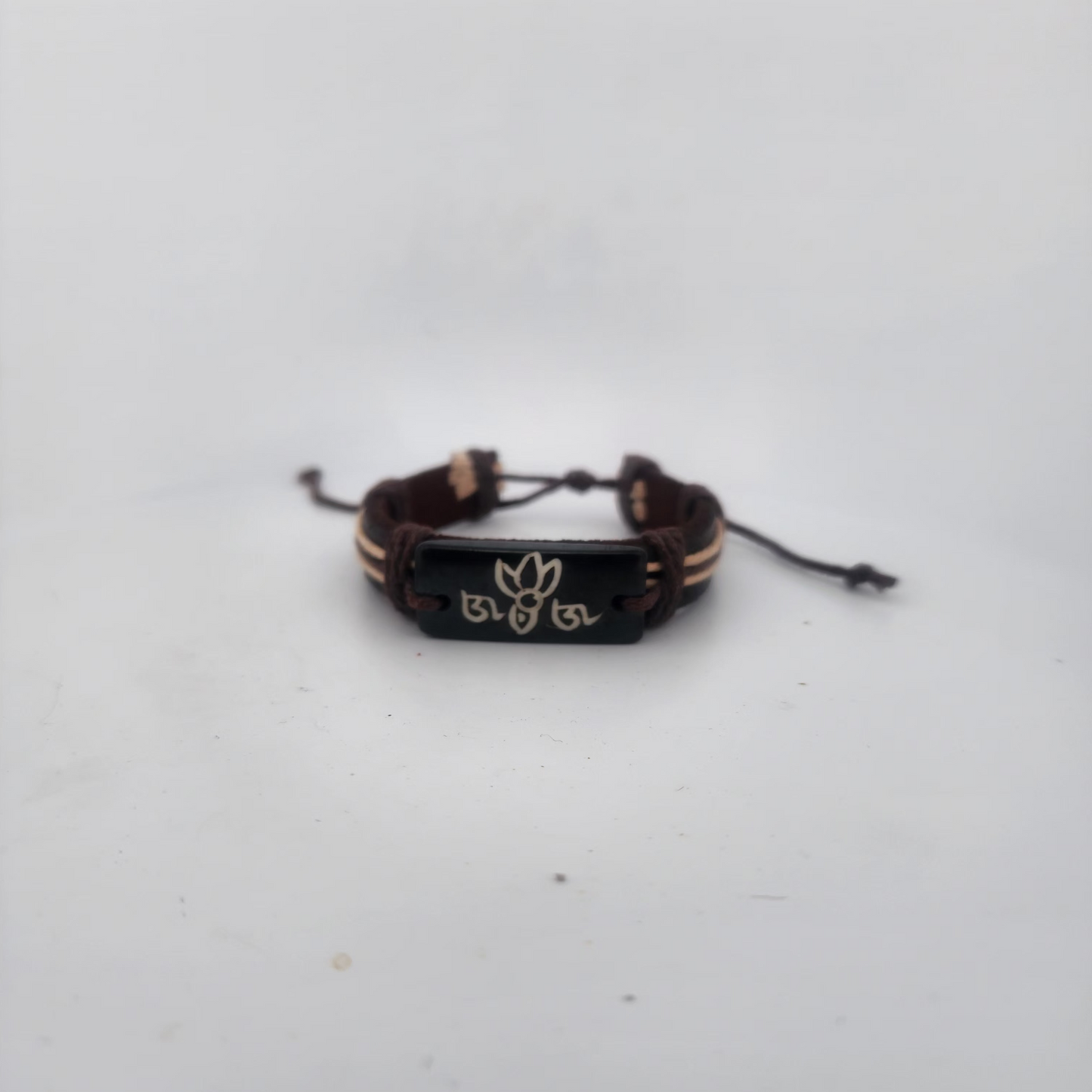 Bracelet with a black clasp and gold accents on a white background