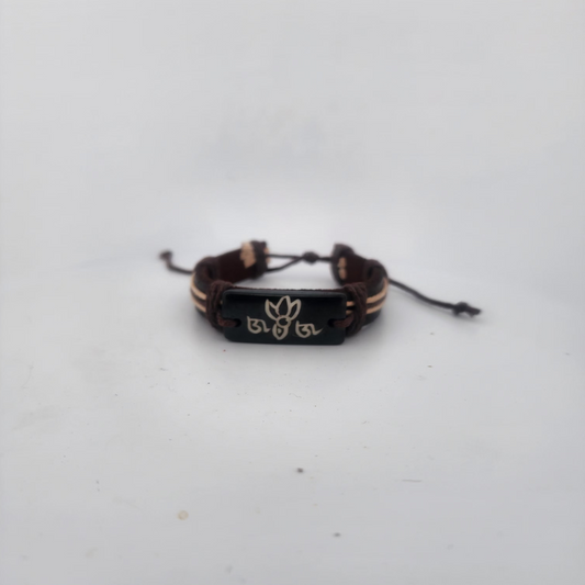 Bracelet with a black clasp and gold accents on a white background
