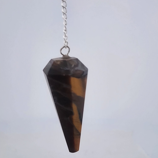 Tiger eye pendulum on a chain against a white background