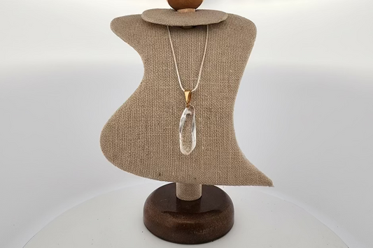 Necklace displayed on a mannequin bust with a plain background