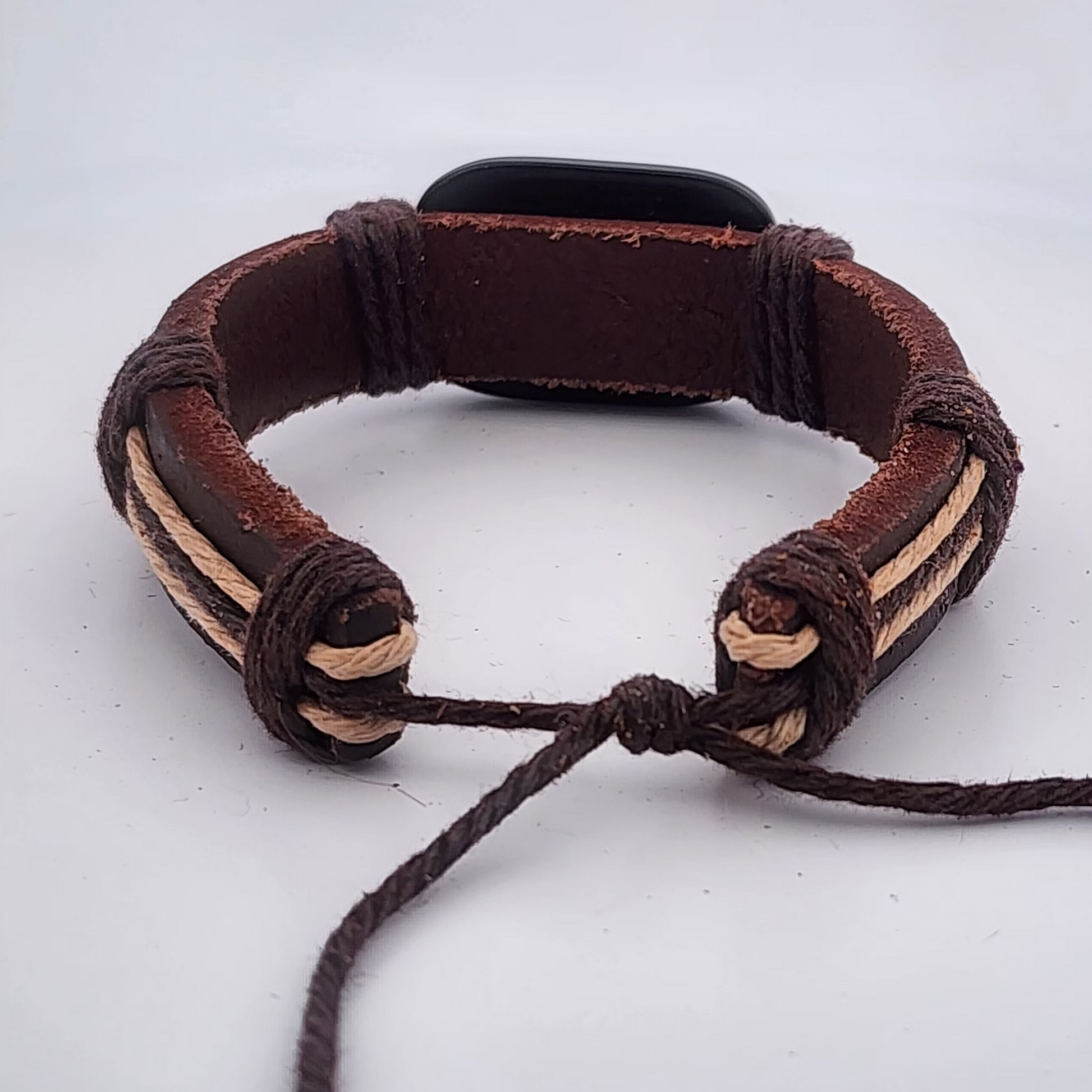 Brown braided leather bracelet on a white background