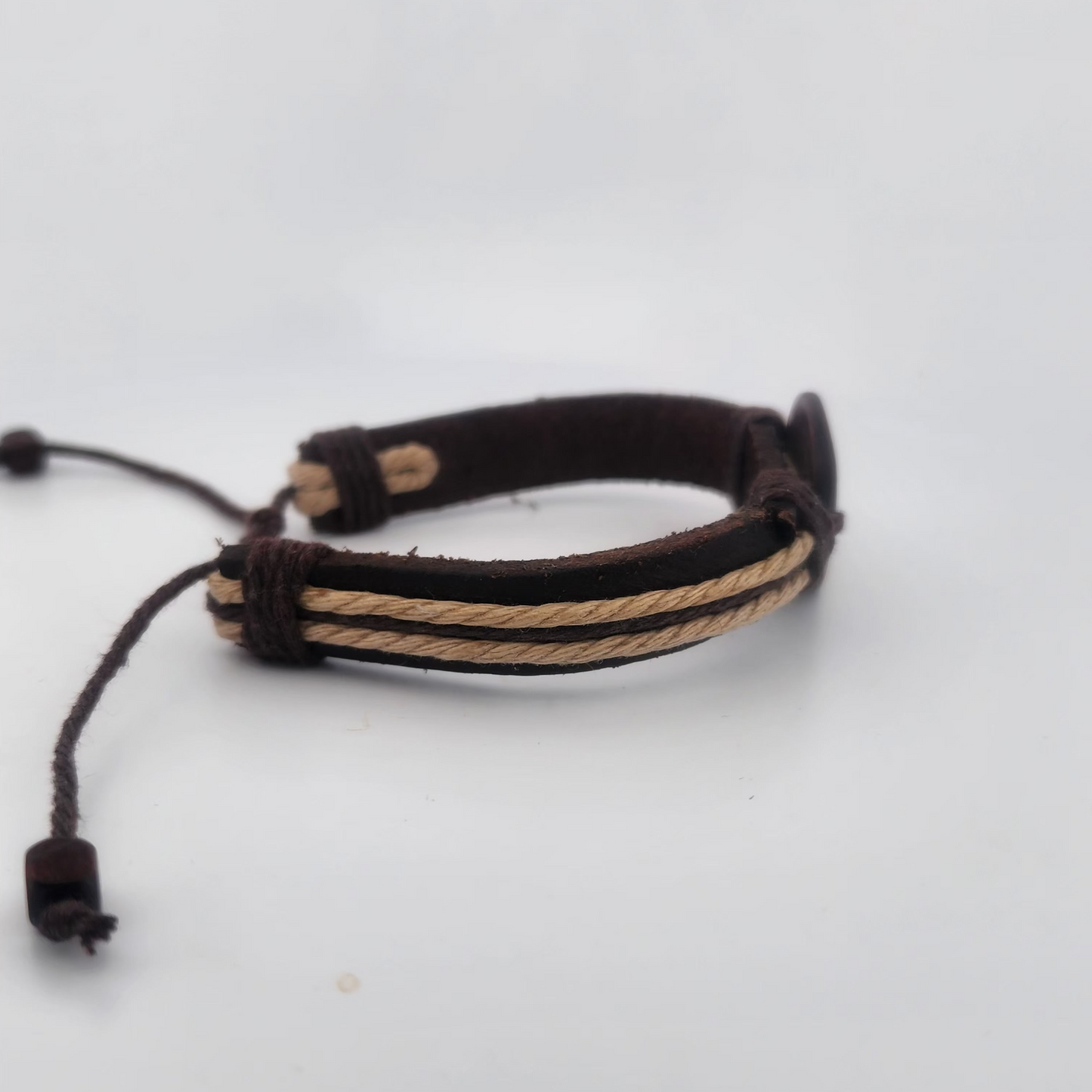Bracelet with brown and beige cord on a white background