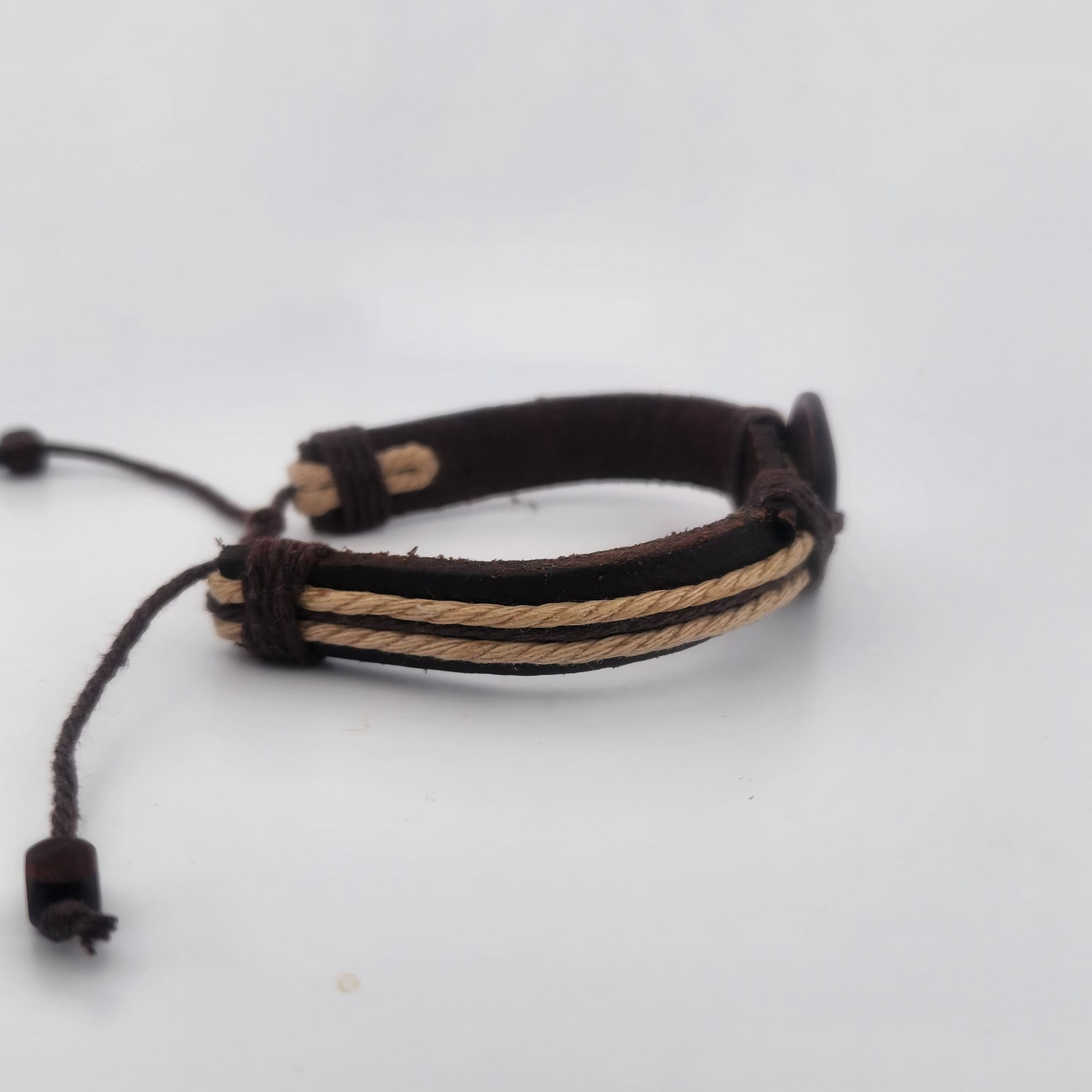 Bracelet with brown and beige cord on a white background
