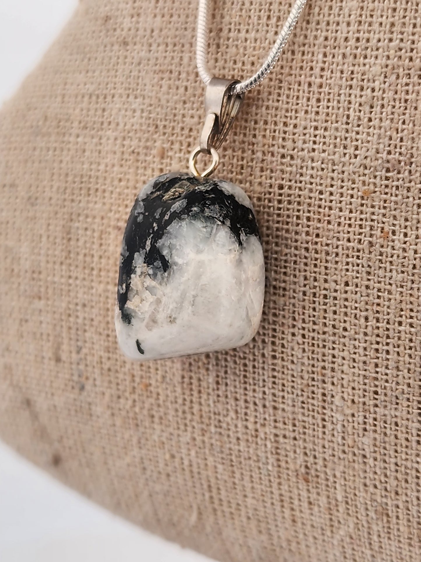 Necklace with a pendant on a beige fabric background