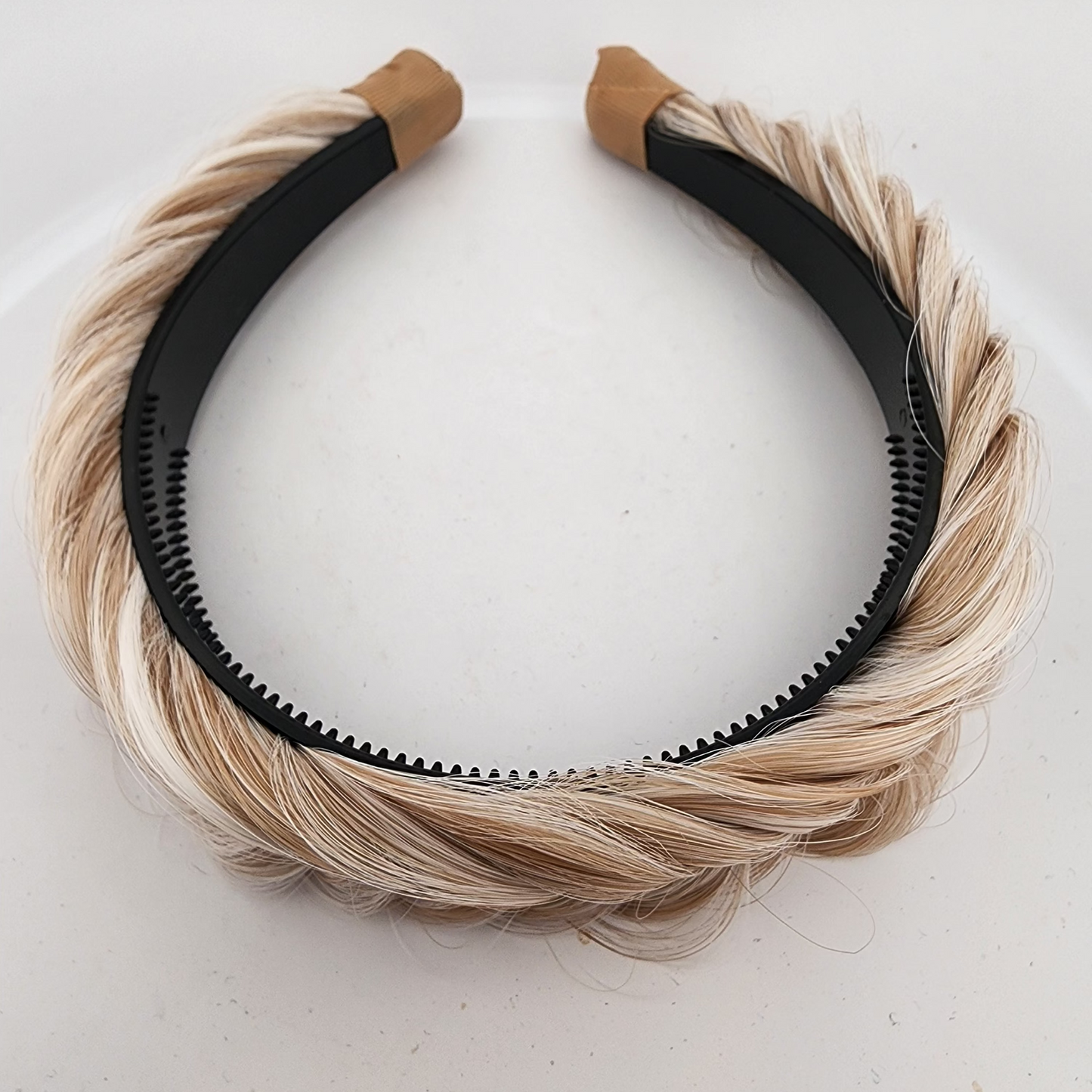 Headband with blonde hair extensions on a white background