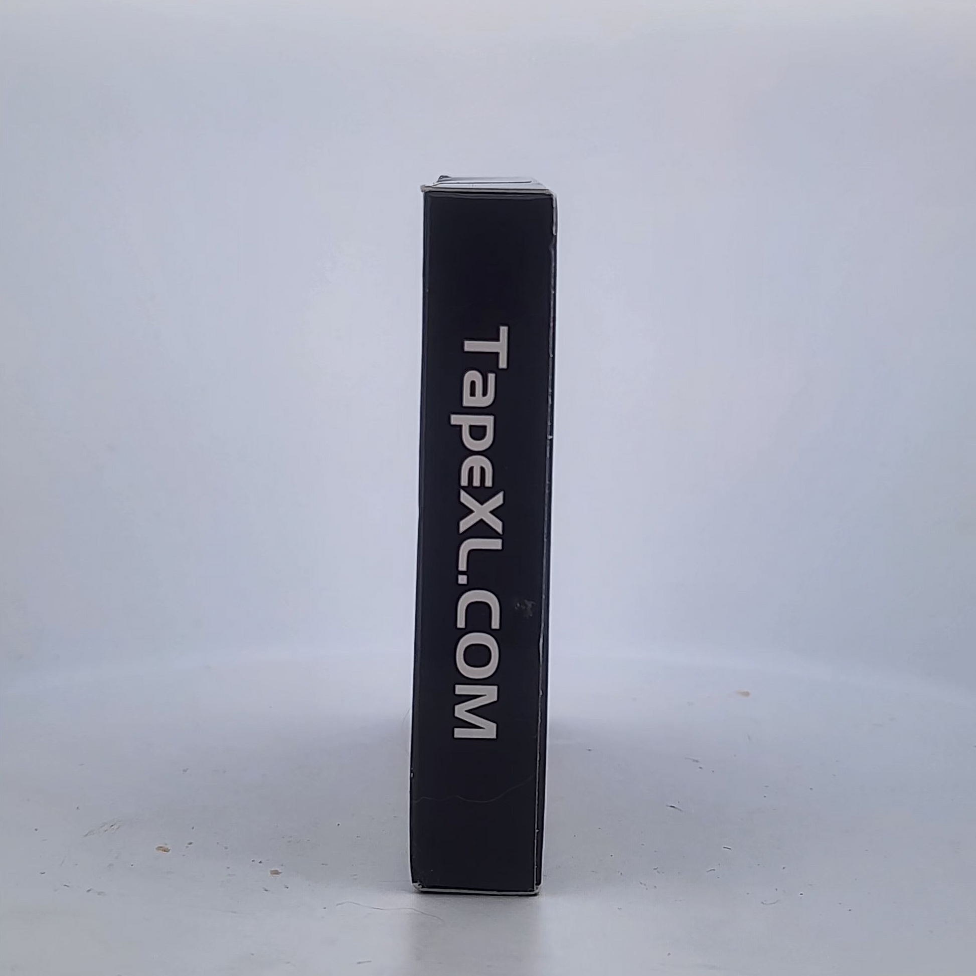 Black rectangular object with 'TapexL.com' text on a white background