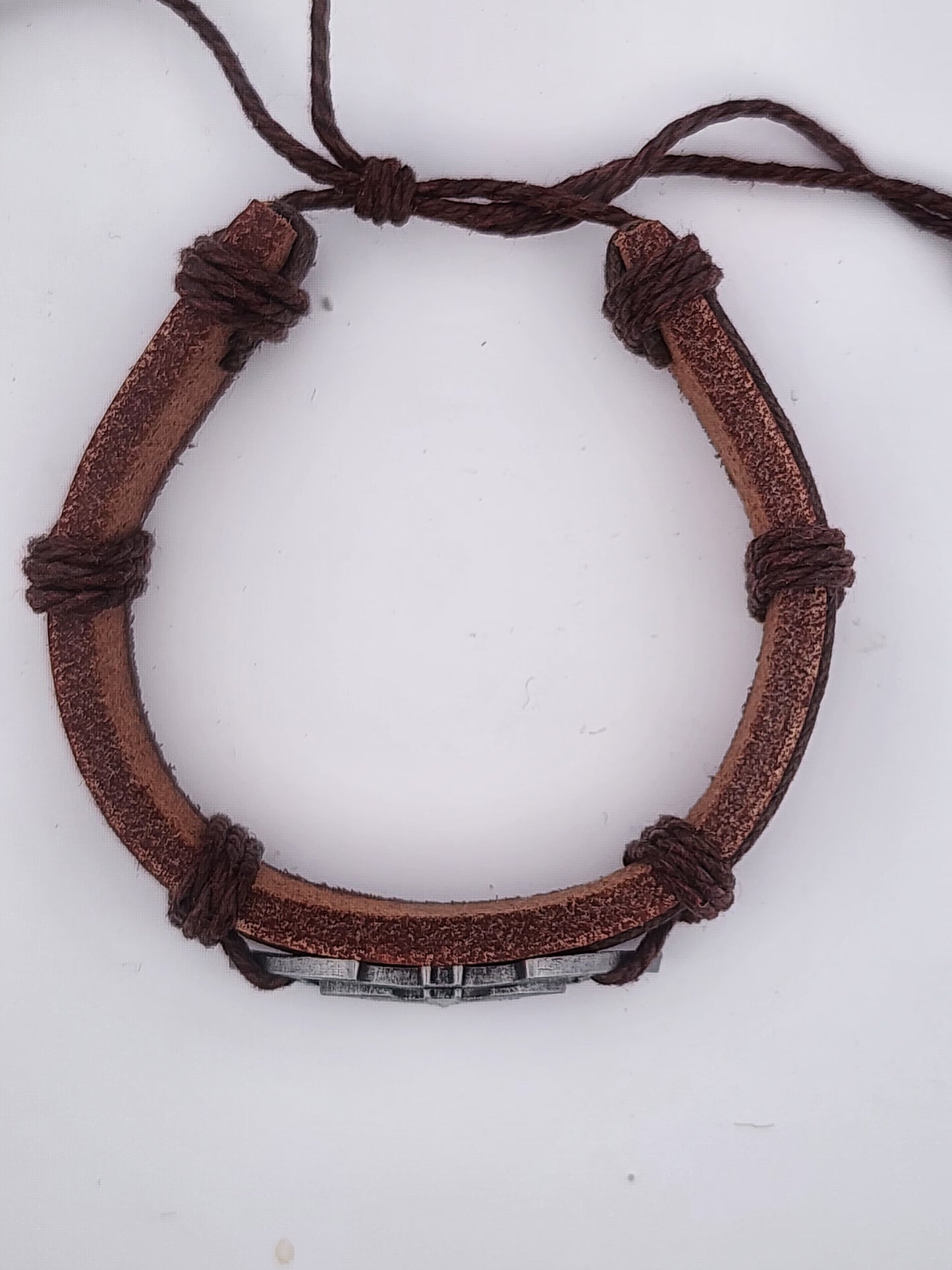 Brown leather bracelet with metal clasp on a white background