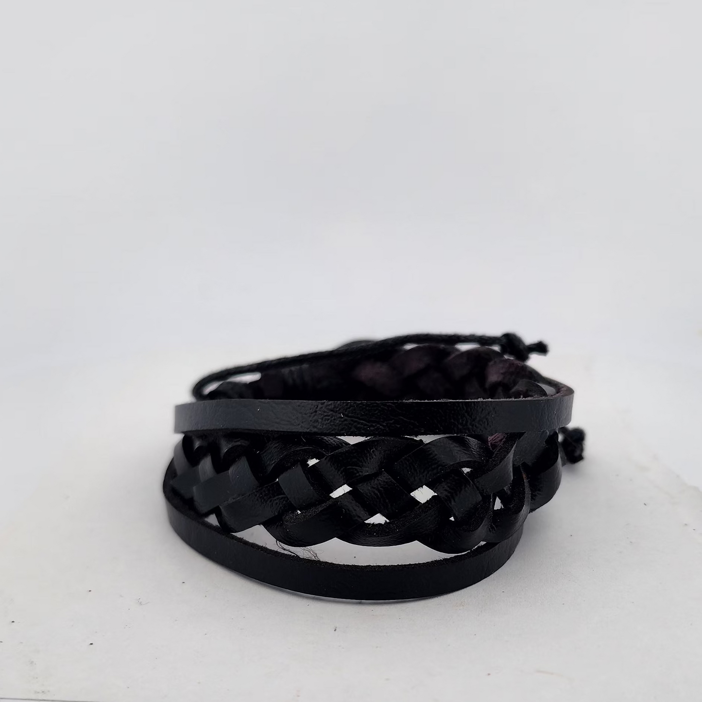 Black woven bracelet on a white background