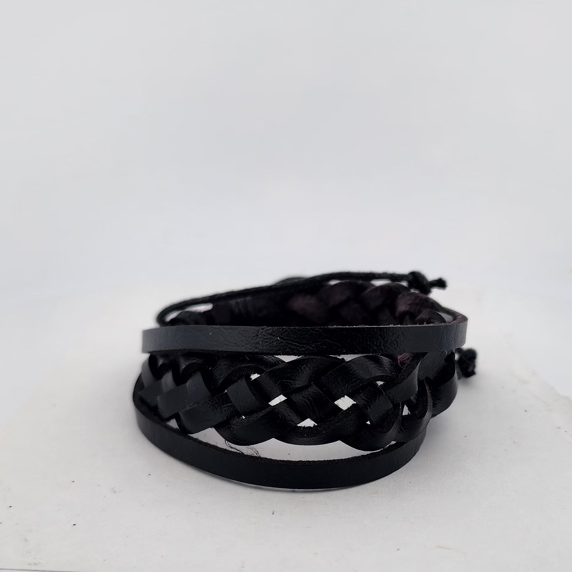 Black woven bracelet on a white background
