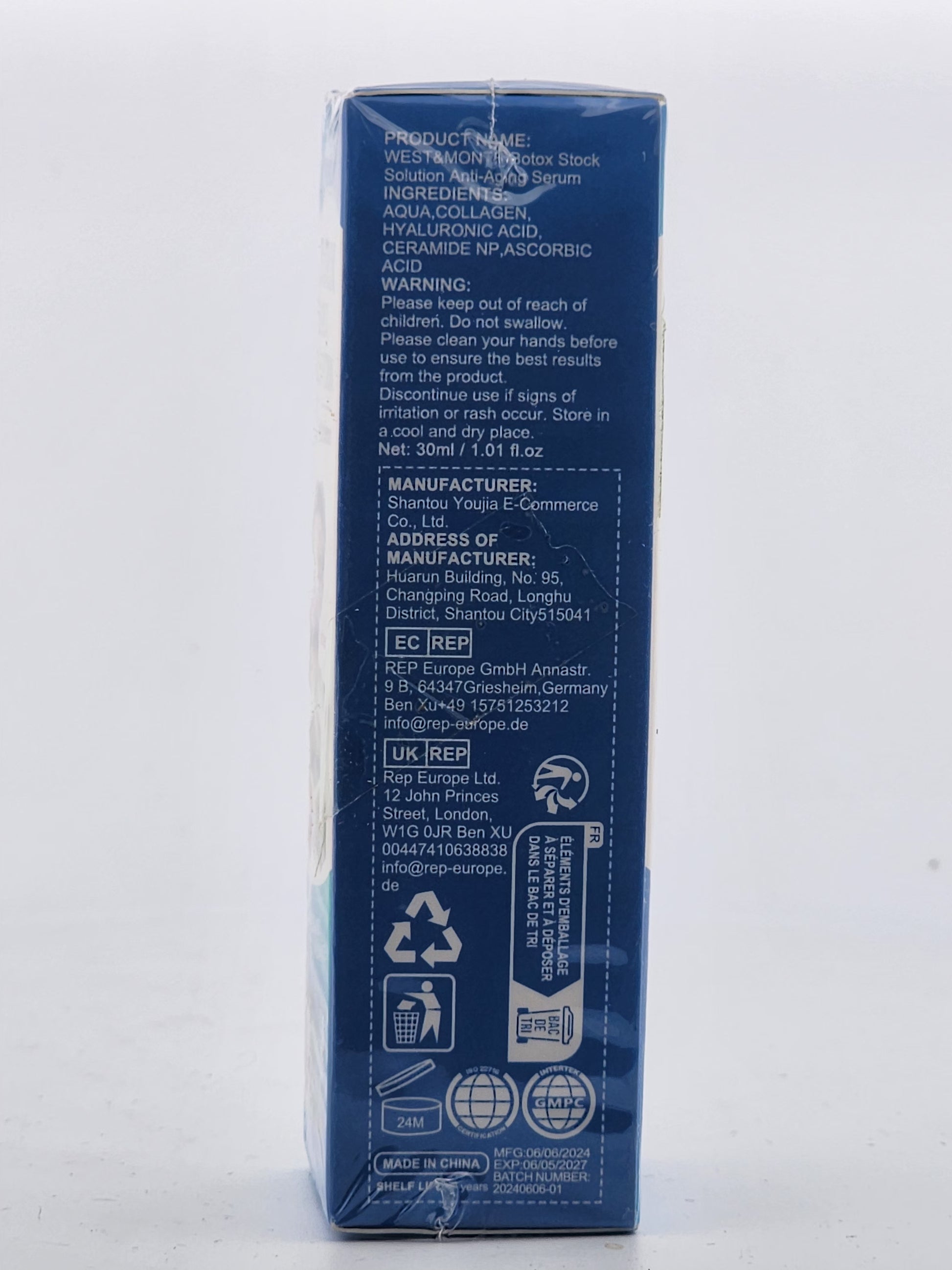 Back view of a blue skincare product packaging with text and symbols on a white background