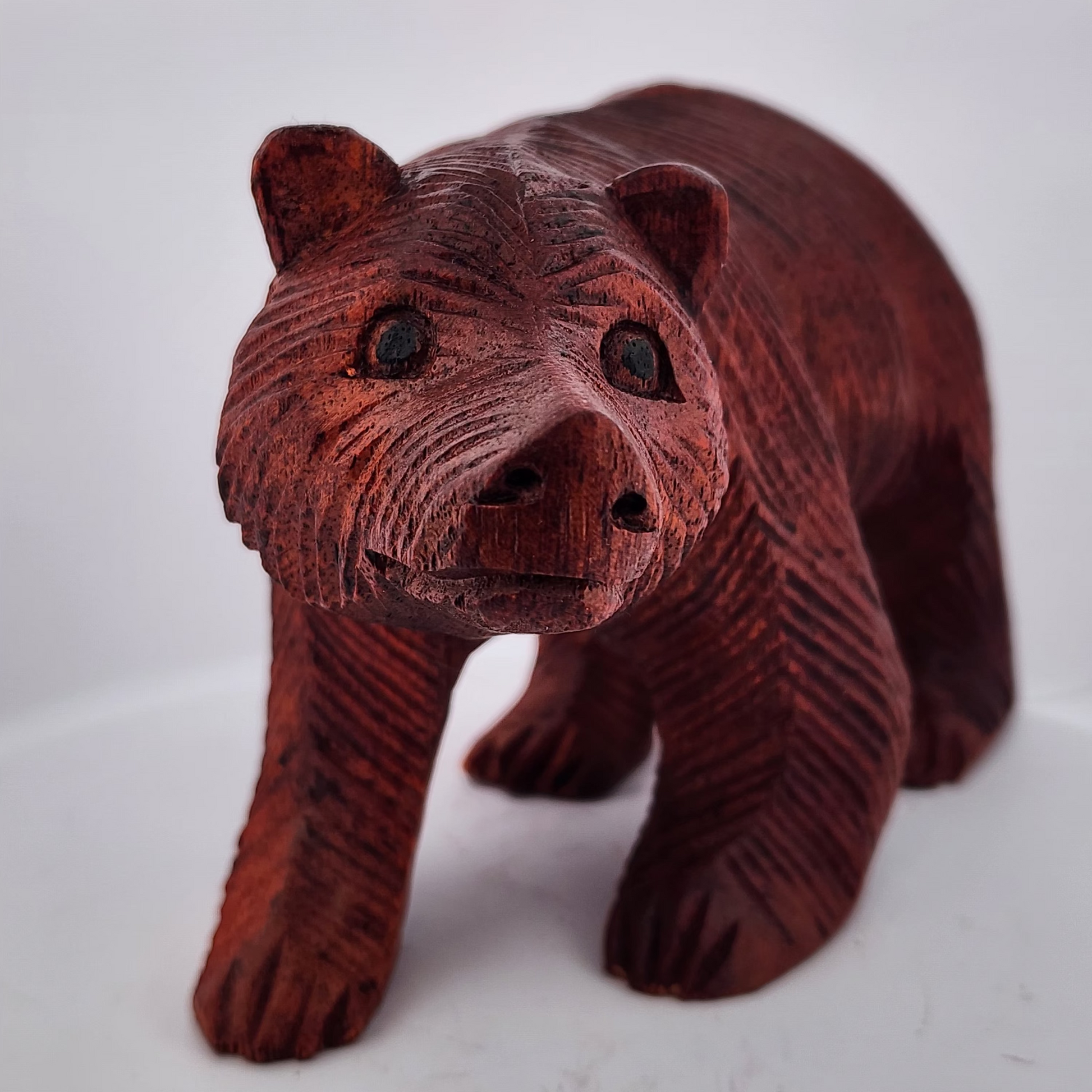 Wooden bear figurine on a white background